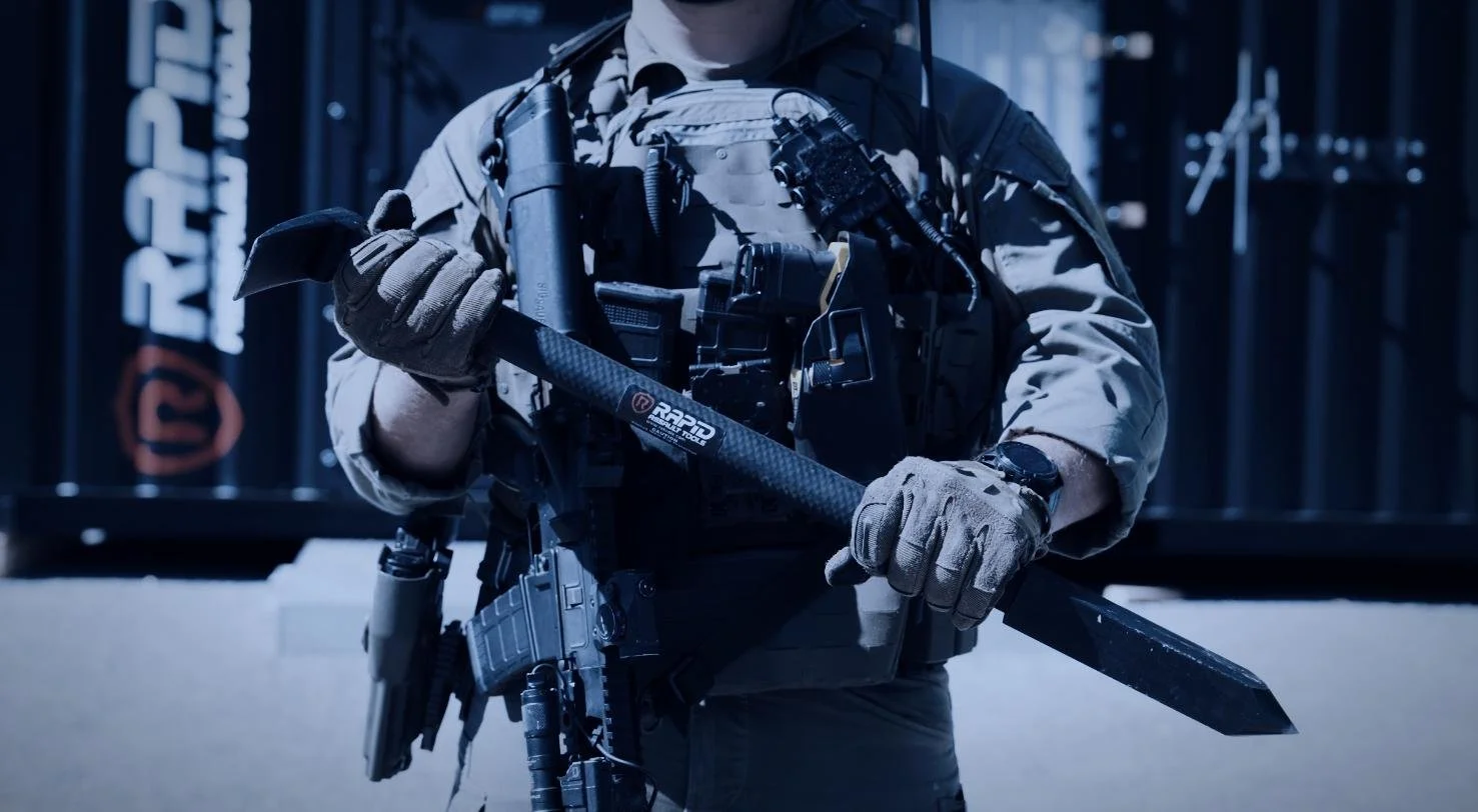 Operator holding a Rapid Assault Tools breaching tool in front of a RAT training container, shot by CXIX Creative Group