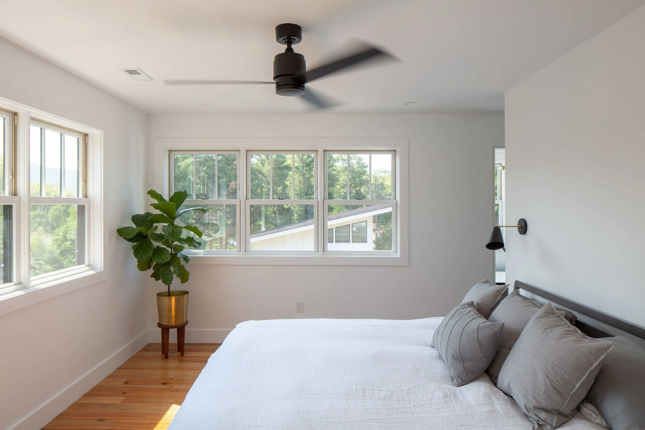 Primary bedroom with mountain views out surrounding windows.