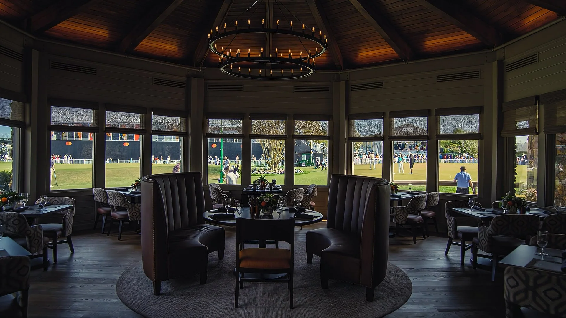 interior of a golf club dining room looking out onto a practice green