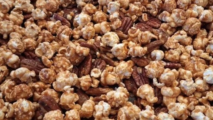 Pecan Pie popcorn, peanut brittle coated in velvety chocolate and dusted with powdered sugar.