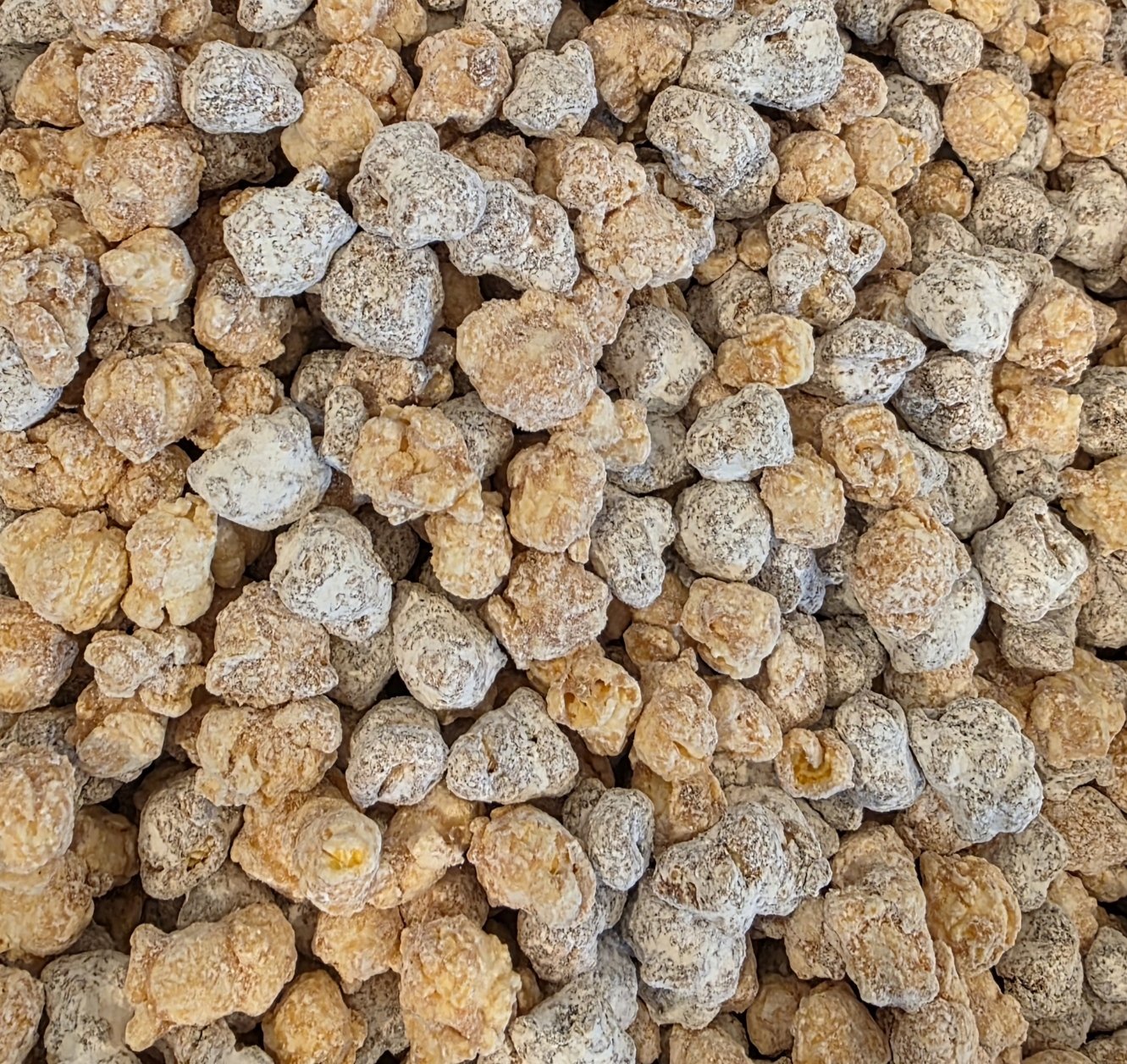Puppy Chow popcorn, peanut brittle coated in velvety chocolate and dusted with powdered sugar.