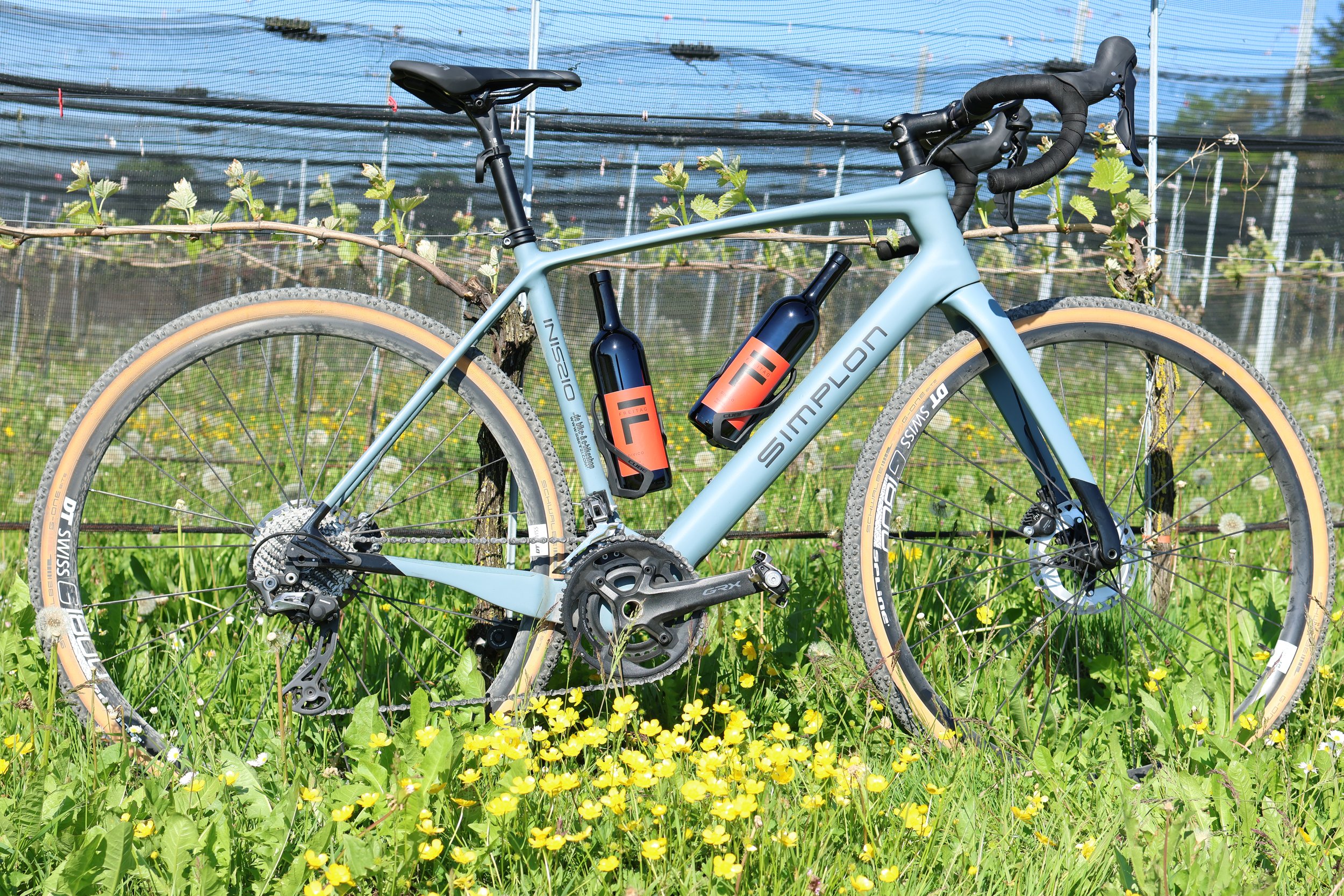 Gravel-Bike im Rebberg vom Rebhus mit Divico-Weinflaschen