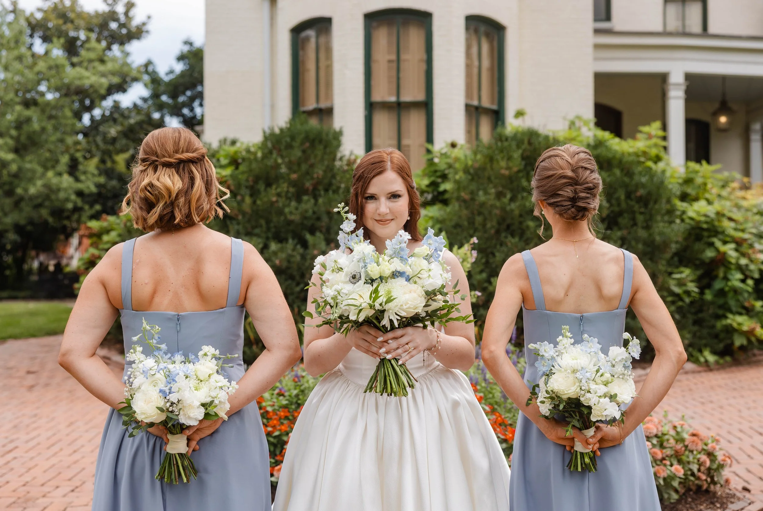 Bride holding her white and blue bridal bouquet