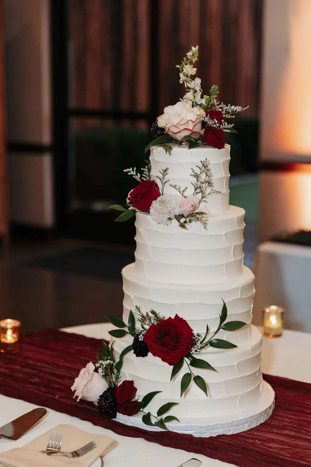 Four tier cake flowers in reds and blush
