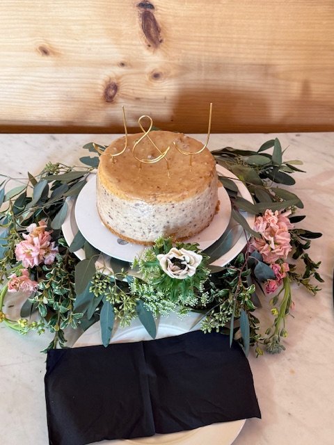 Rustic Greenery and blooms around base of cake