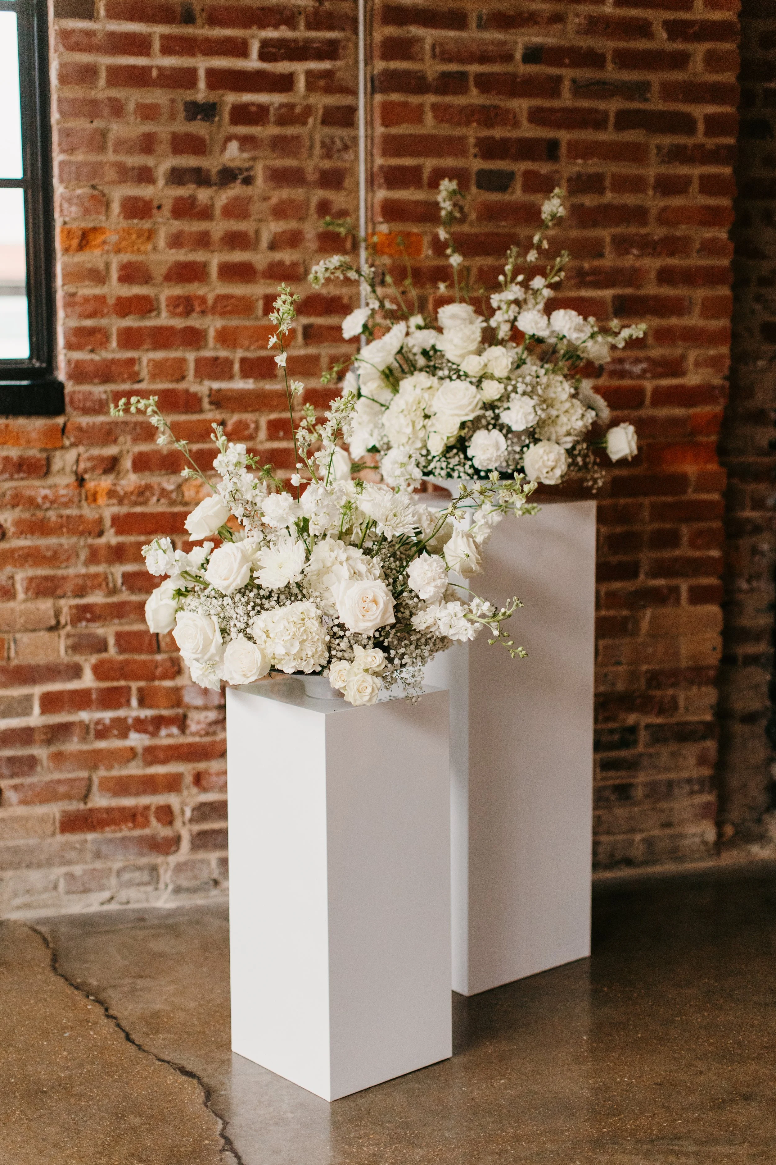 Set of altar arrangements in all white, mirrored on the other side.