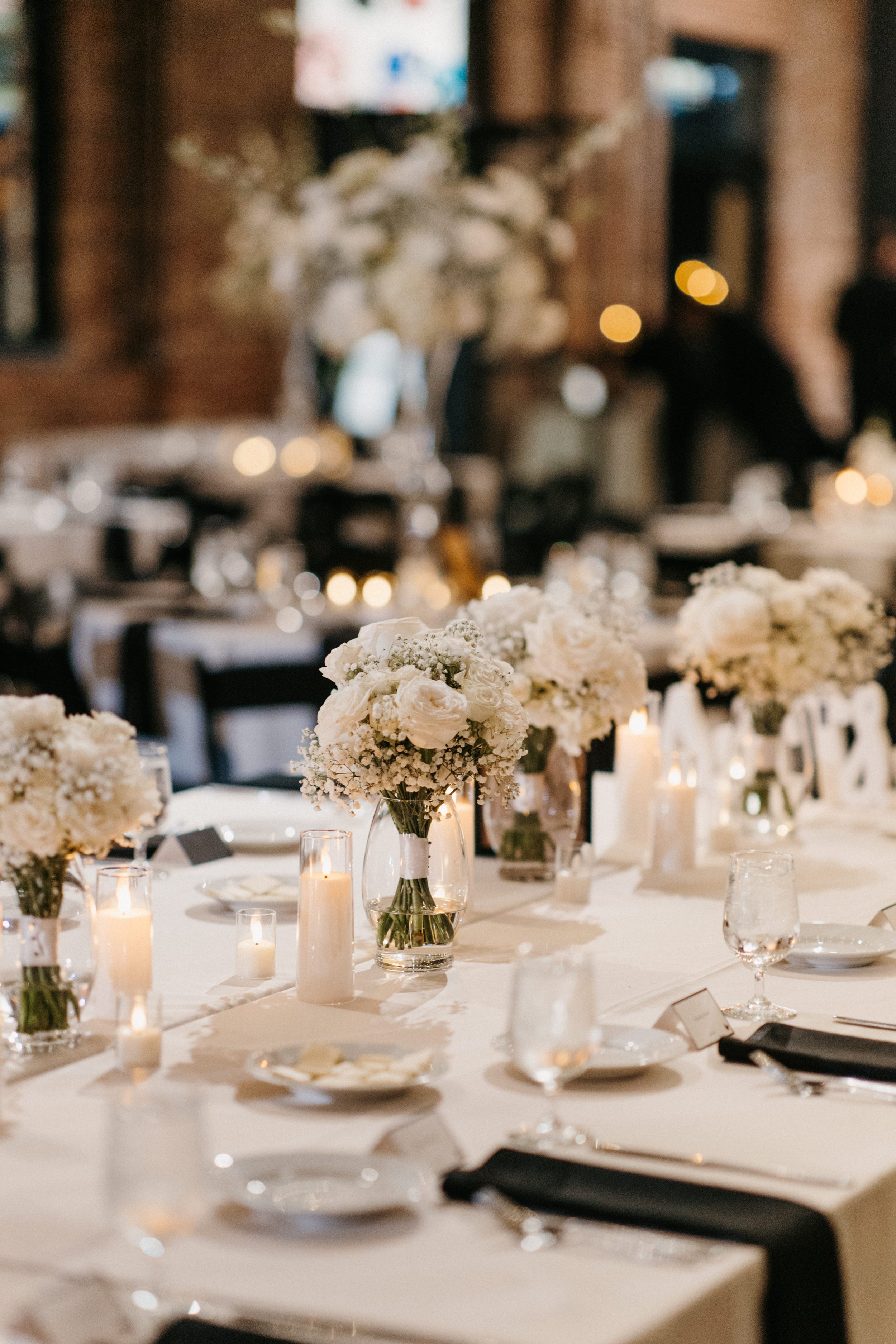 Repurposed bridal bouquets on the head table for the reception.