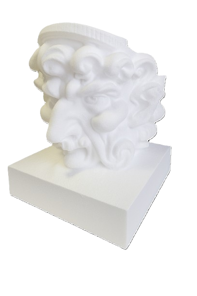 White sculpture of a lion's head on a square base.