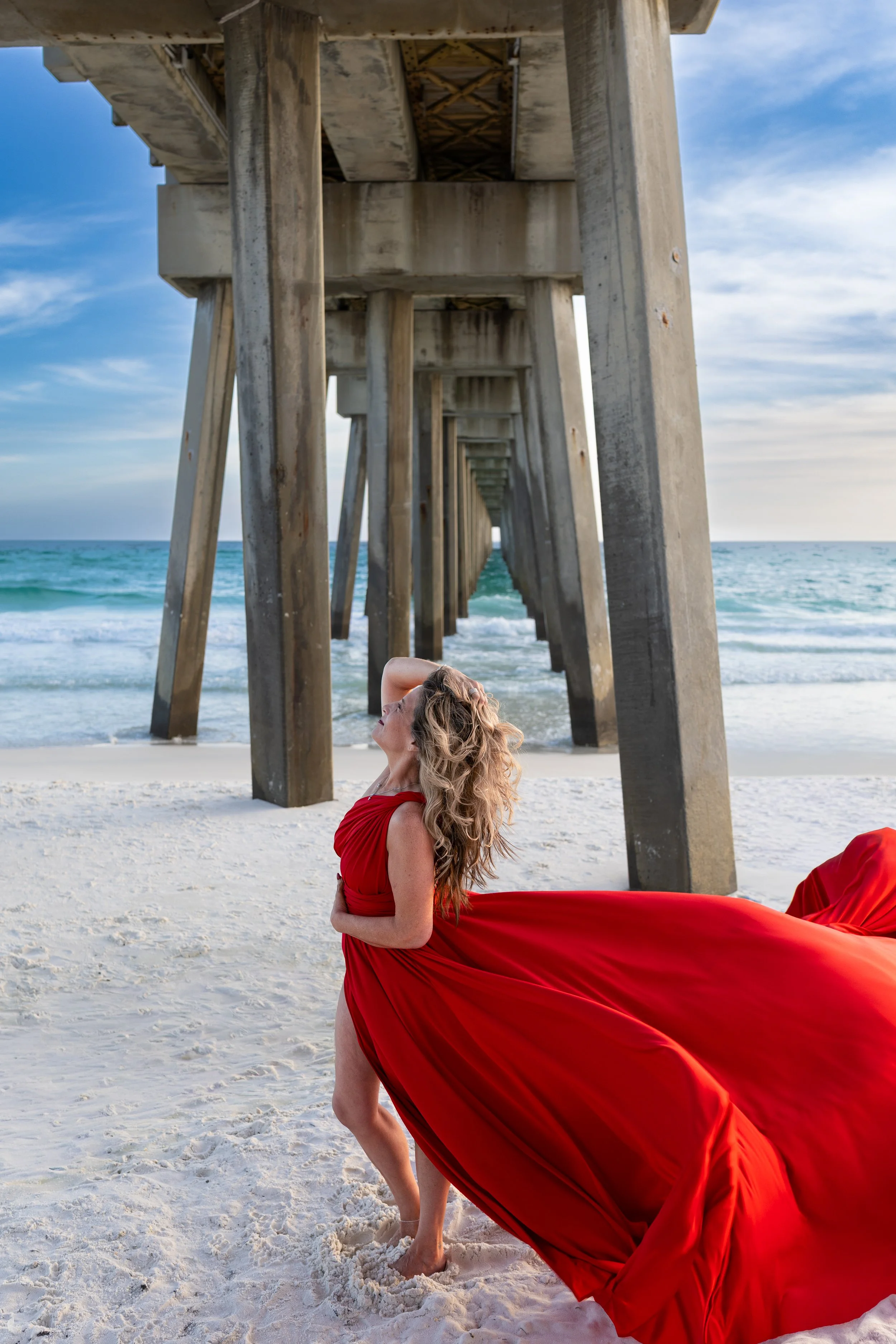 red flying dress under pier at Florida beach