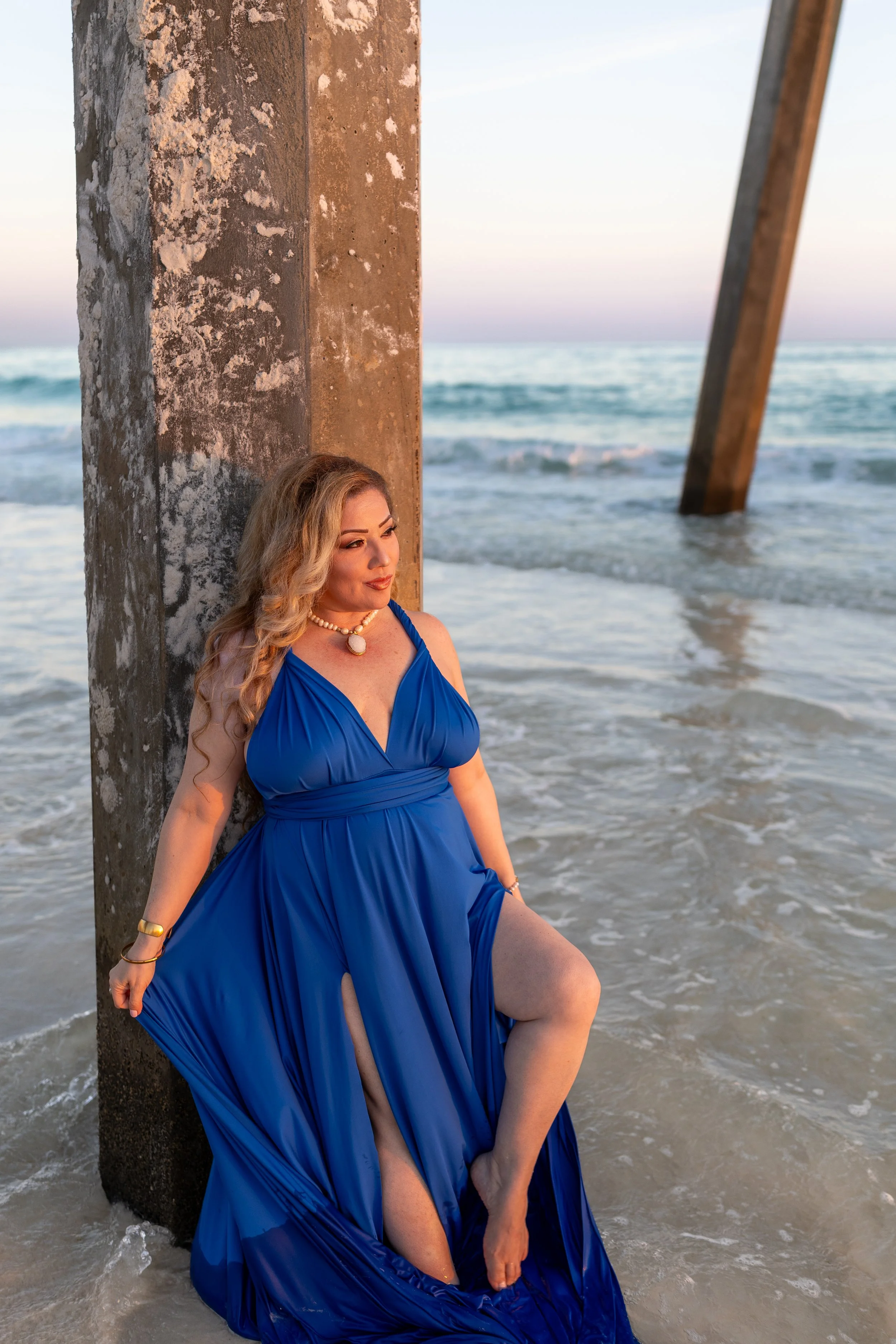 Model flying dress pier sunset blue dress beach