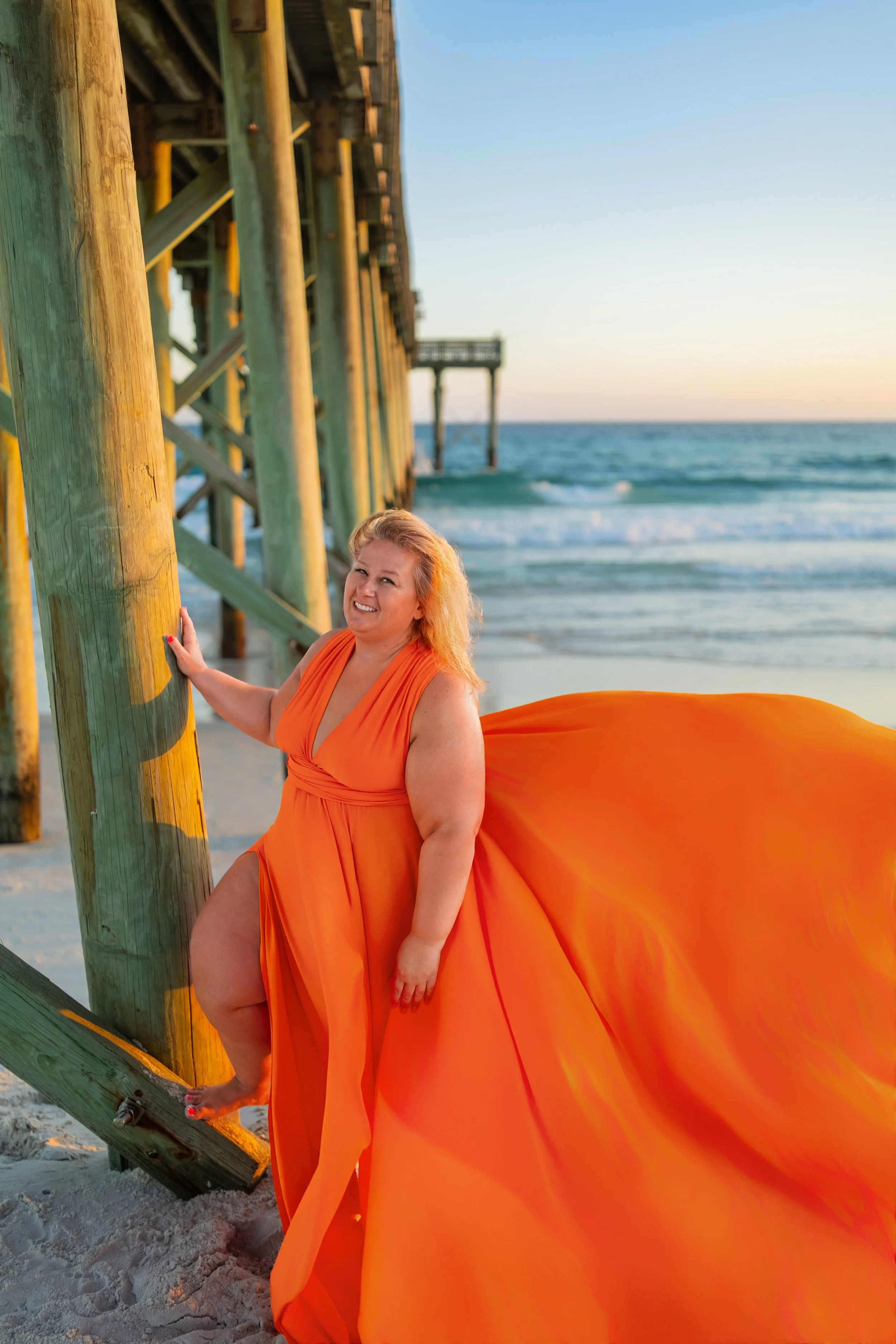 orange flying dress at the pier