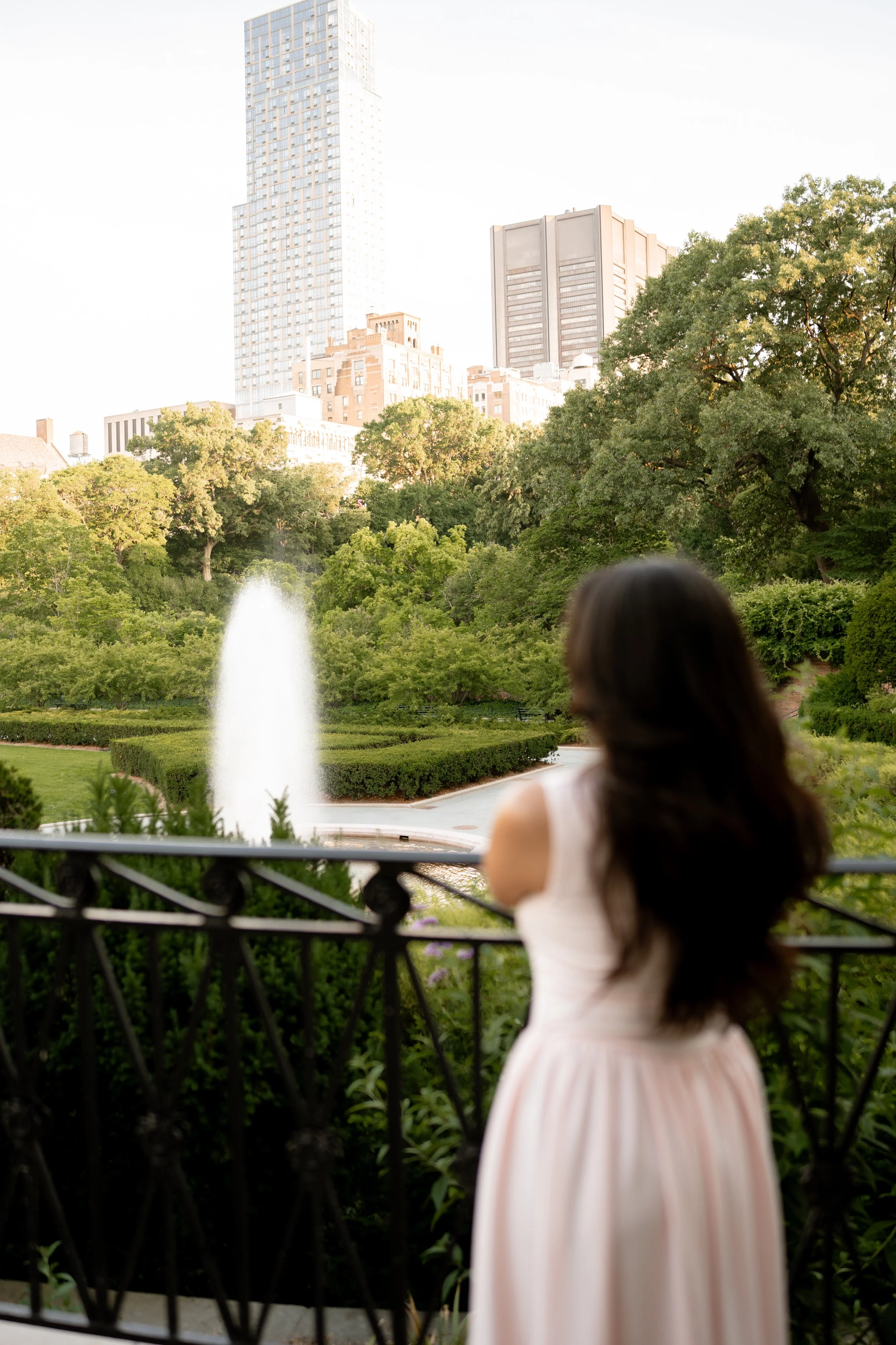 Calista Hennie, looking at a fountain in the distance at Central Park.