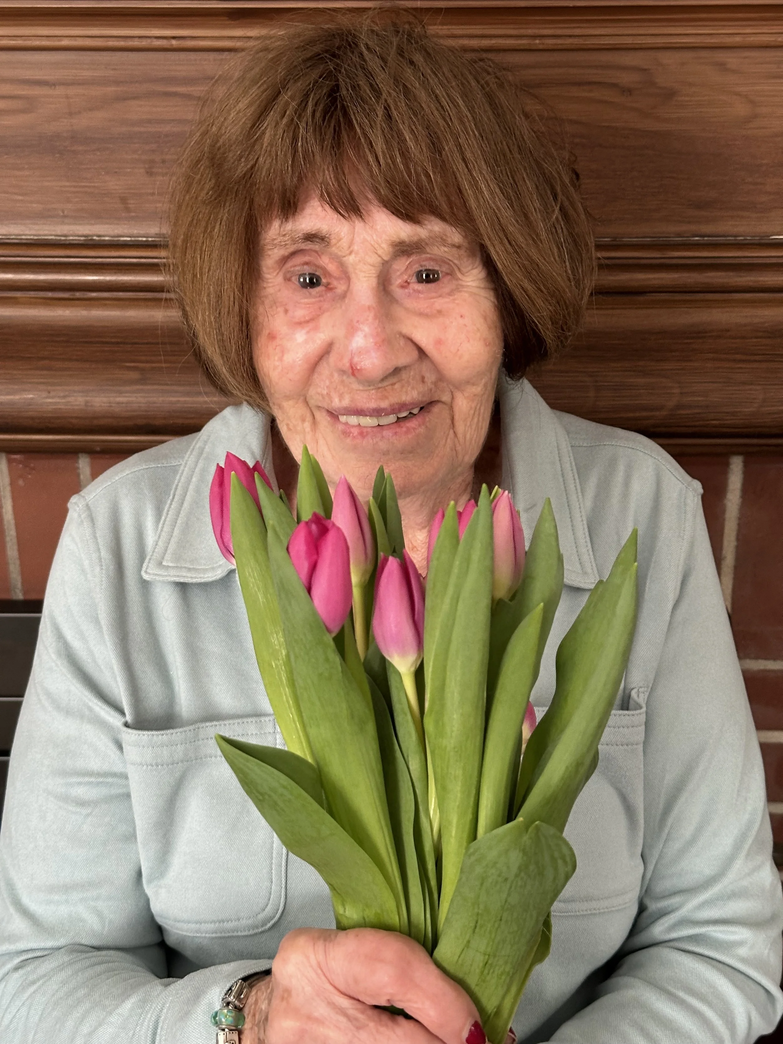 Tulips held by a Senior Citizens that brings a smile to their face.