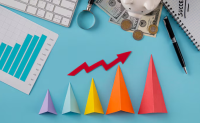 colorful paper triangles arranged small to big under a red arrow trending up