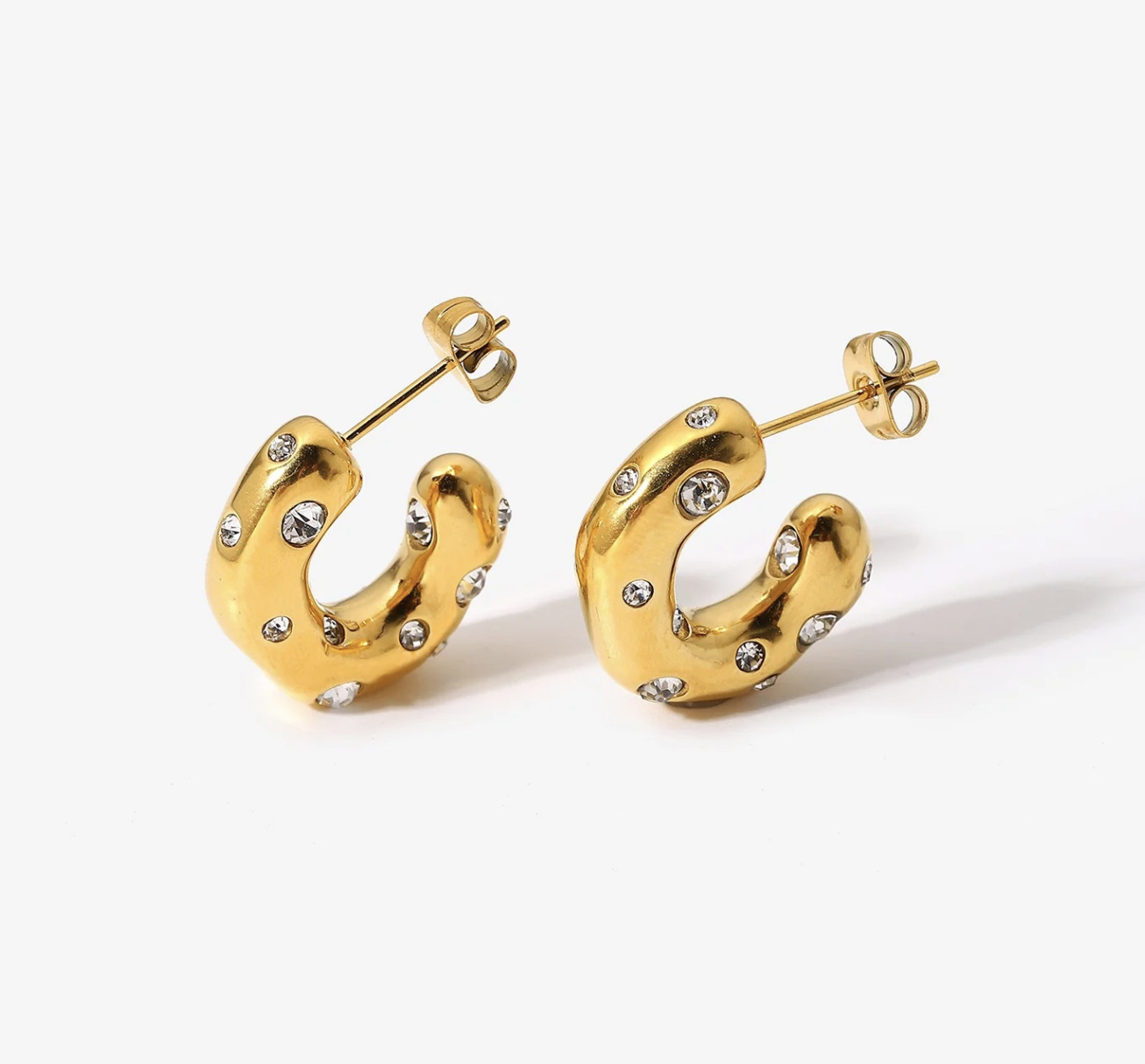 Gold hoop earrings with embedded gemstones on white background.