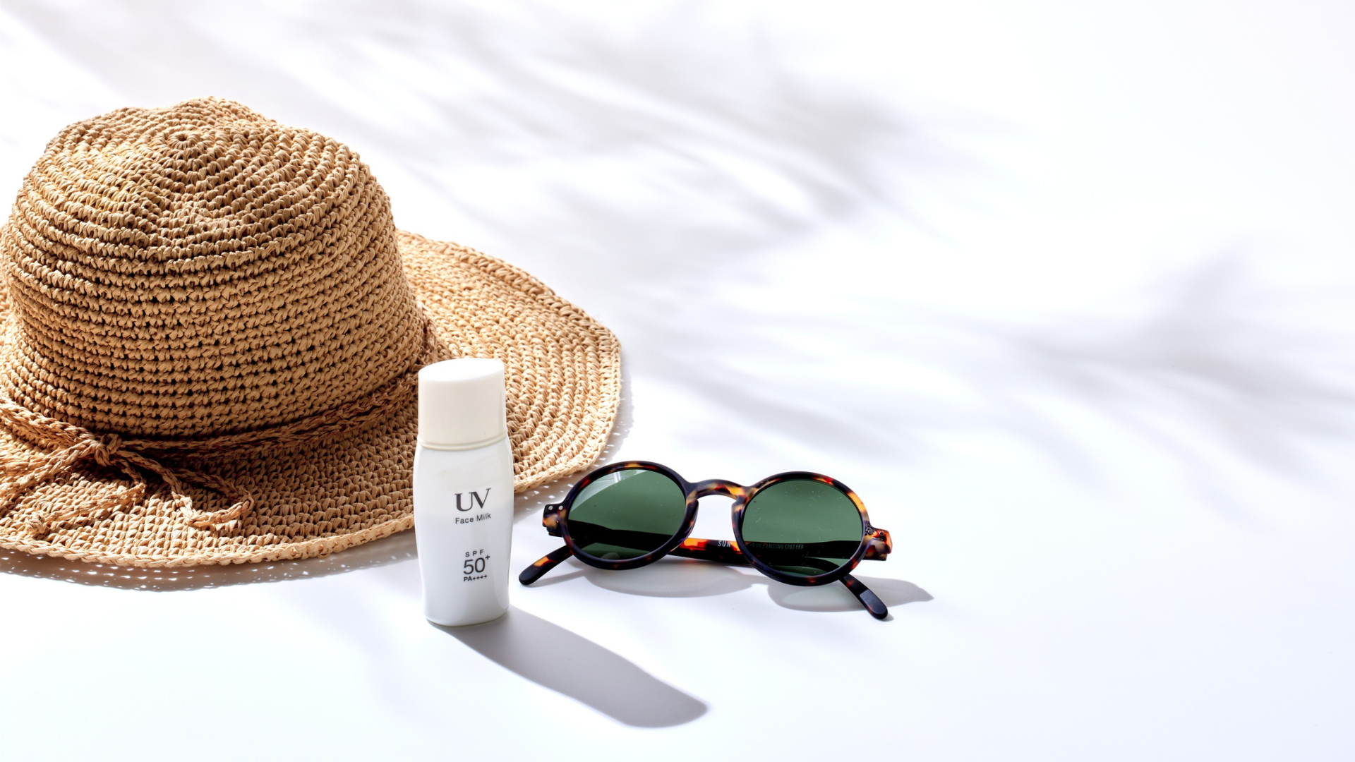 Gold flower-shaped earrings with pearl clusters on white fabric.