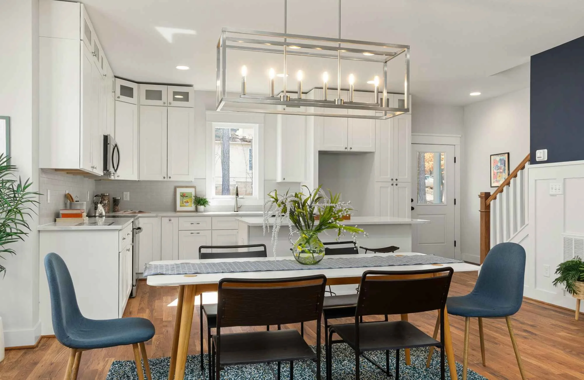trisha-davis-designs-chicago-il-designing-for-full-gut-reno-kitchen-and-dining-white-cabinets-and-countertops-blue-upholstered-chairs-wood-floors.jpg