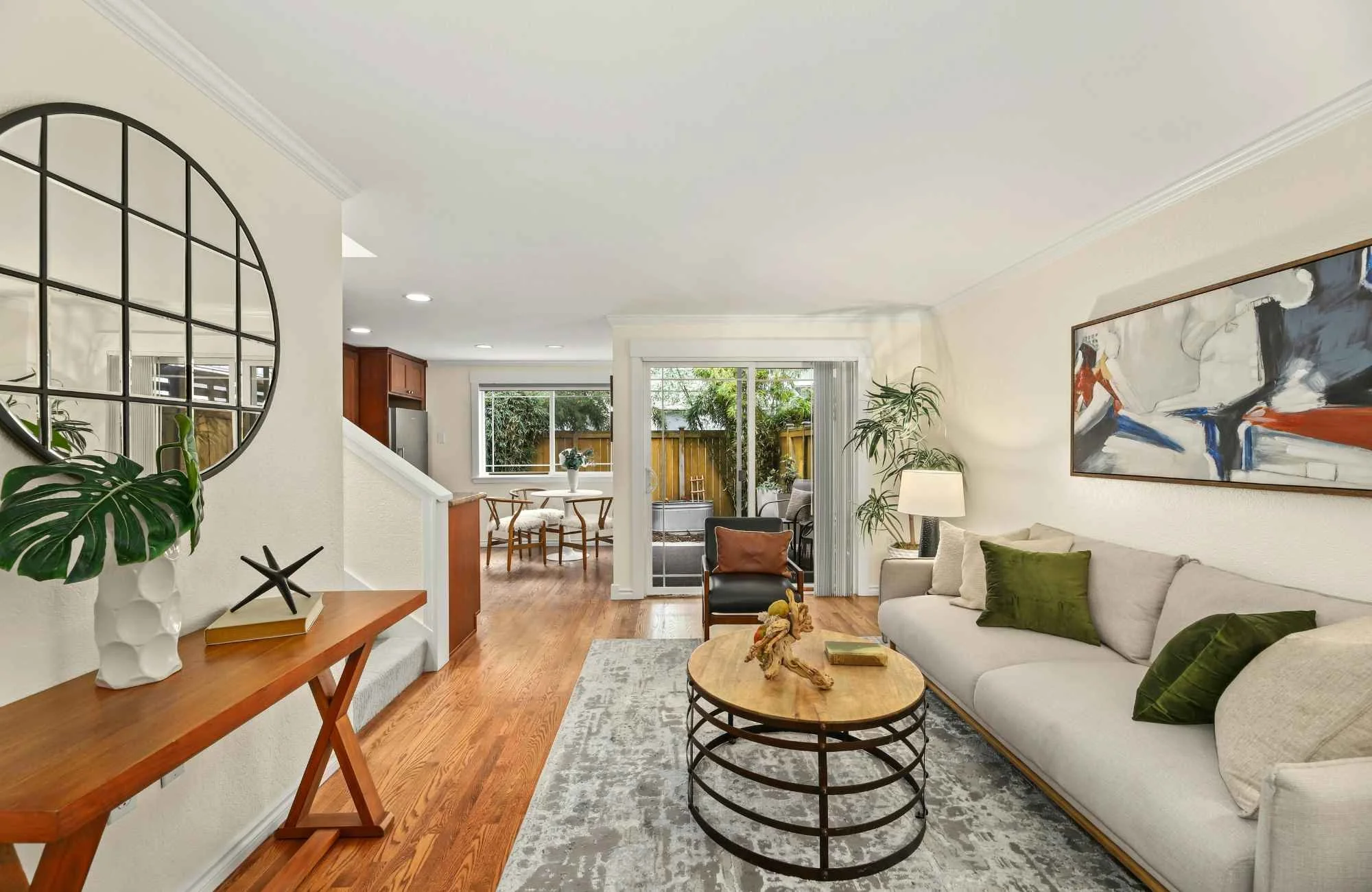 trisha-davis-designs-chicagoland-il-designing-for-full-gut-reno-living-room-with-round-mirror-neutral-colors-contemporary-art-wood-floors-personal.jpg