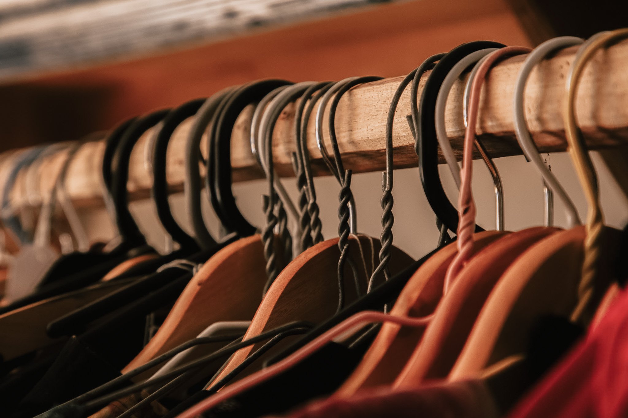 Wooden hangers on clothing rack
