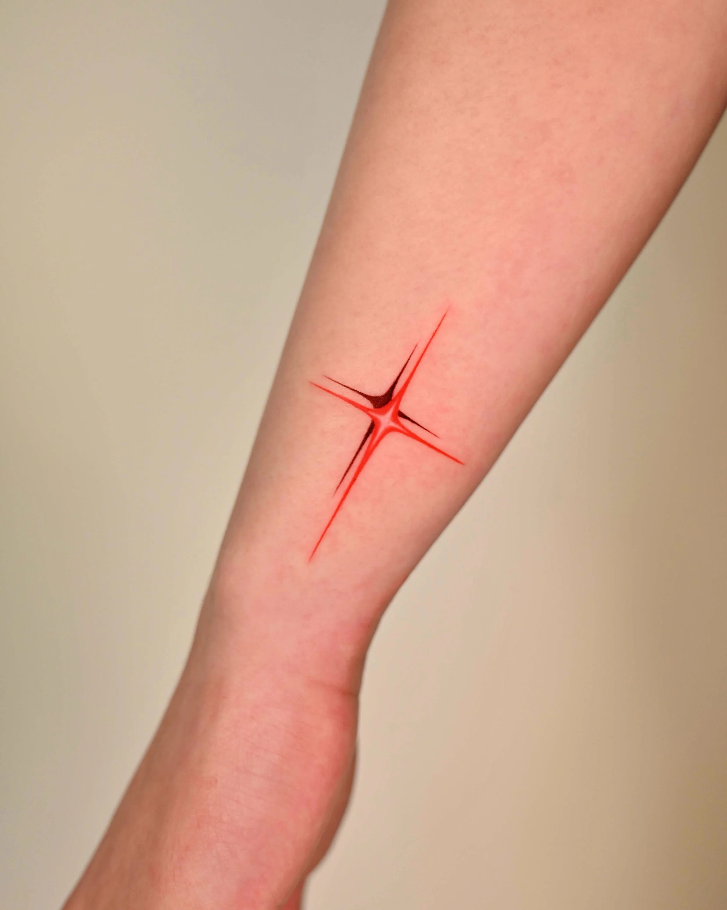 Red chrome star arm tattoo by Megink.