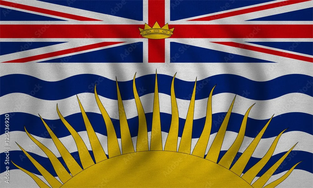 Flag of British Columbia with a Union Jack, wavy blue and white stripes, and a sun with rays at the bottom.