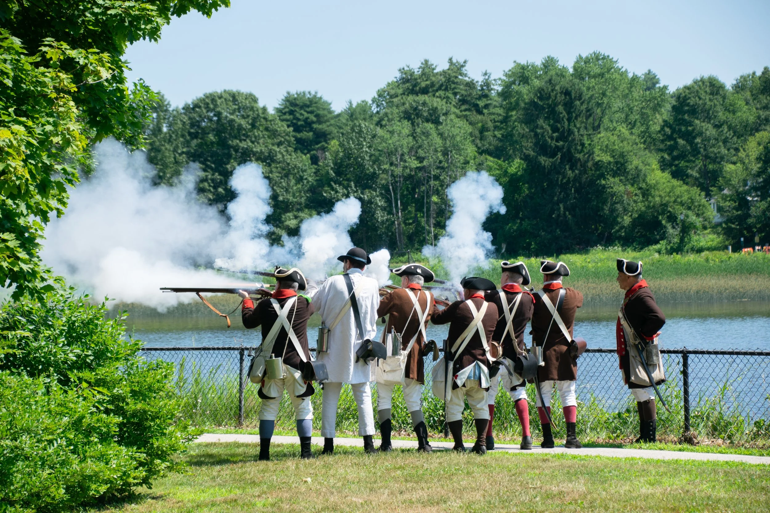 Members of the New Hampshire 1st Regiment fire muskets in a reenactment at Swasey Parkway. Grace Chai/Seacoastonline