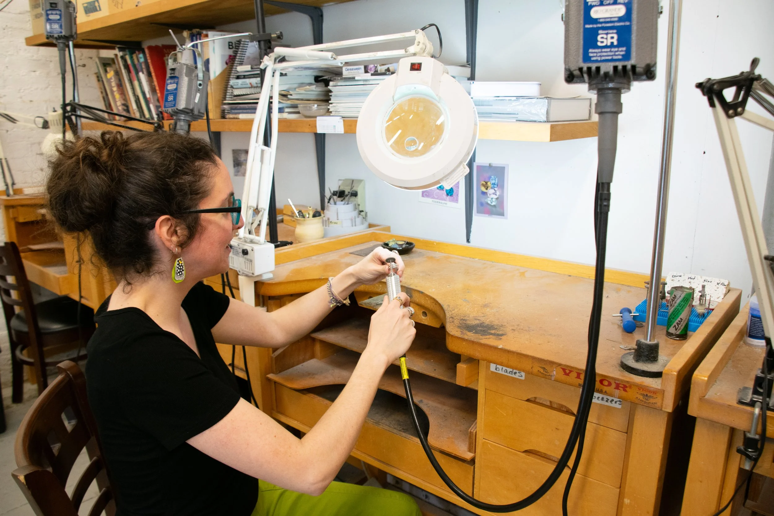 Tif Farmakis-Day demonstrates buffing a ring at the jewelry station at Exeter Fine Crafts' downstairs studio July 21, 2026. Grace Chai/Seacoastonline