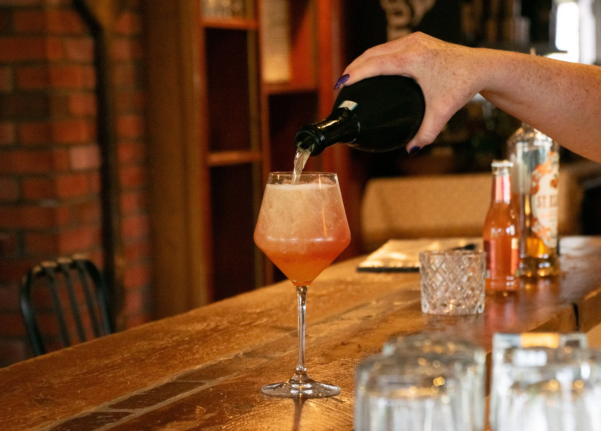 Maggie Dodge, SottoCello's floor manager, prepares the "Il Cornicello," a refreshing drink made with vodka, blood orange liqueur, passion fruit liqueur, blood orange juice, fresh lime and prosecco. Grace Chai/Seacoastonline