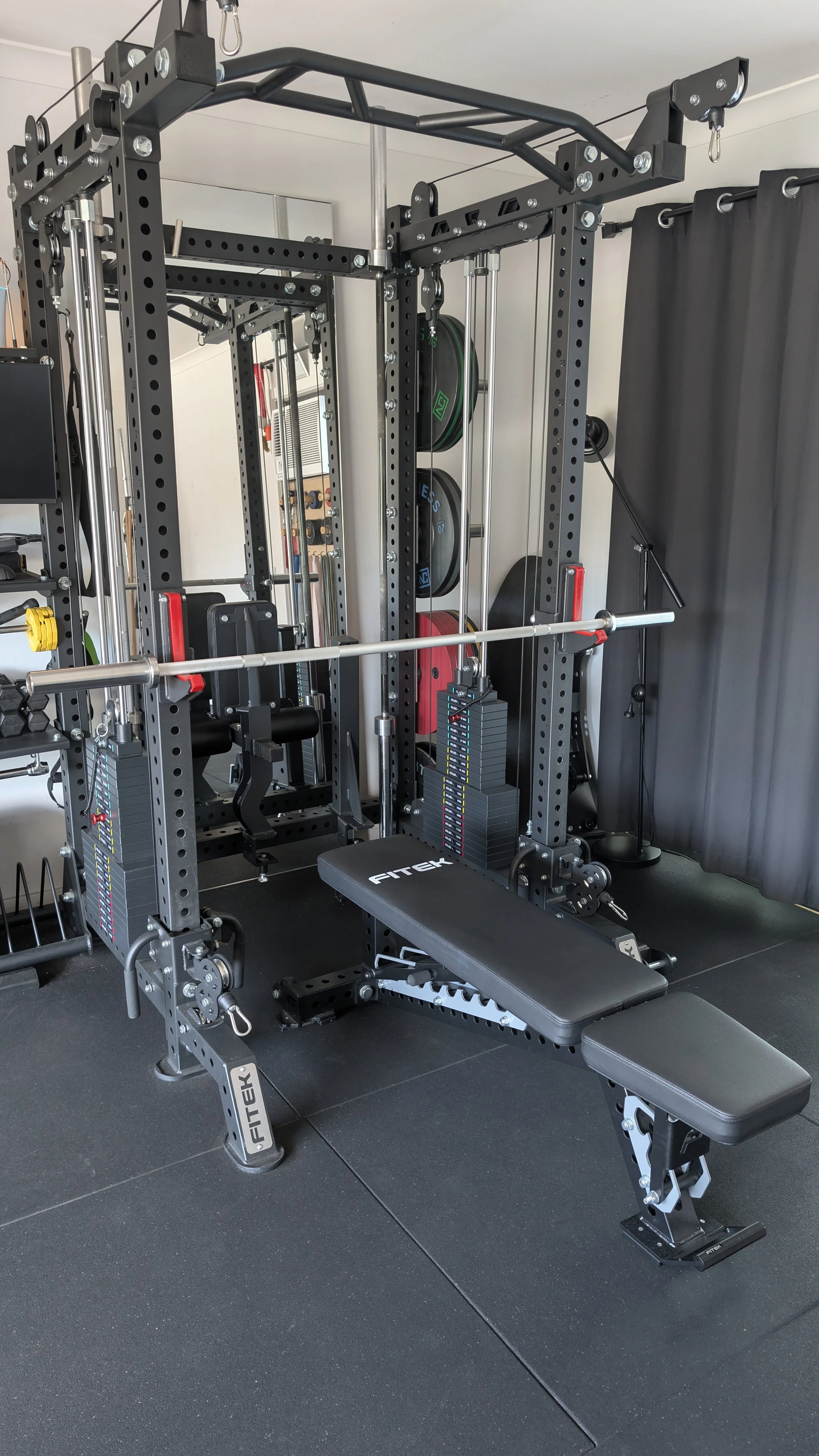 FITEK Adjustable Bench being shown in the Cage with barbell set up for bench press exercise.