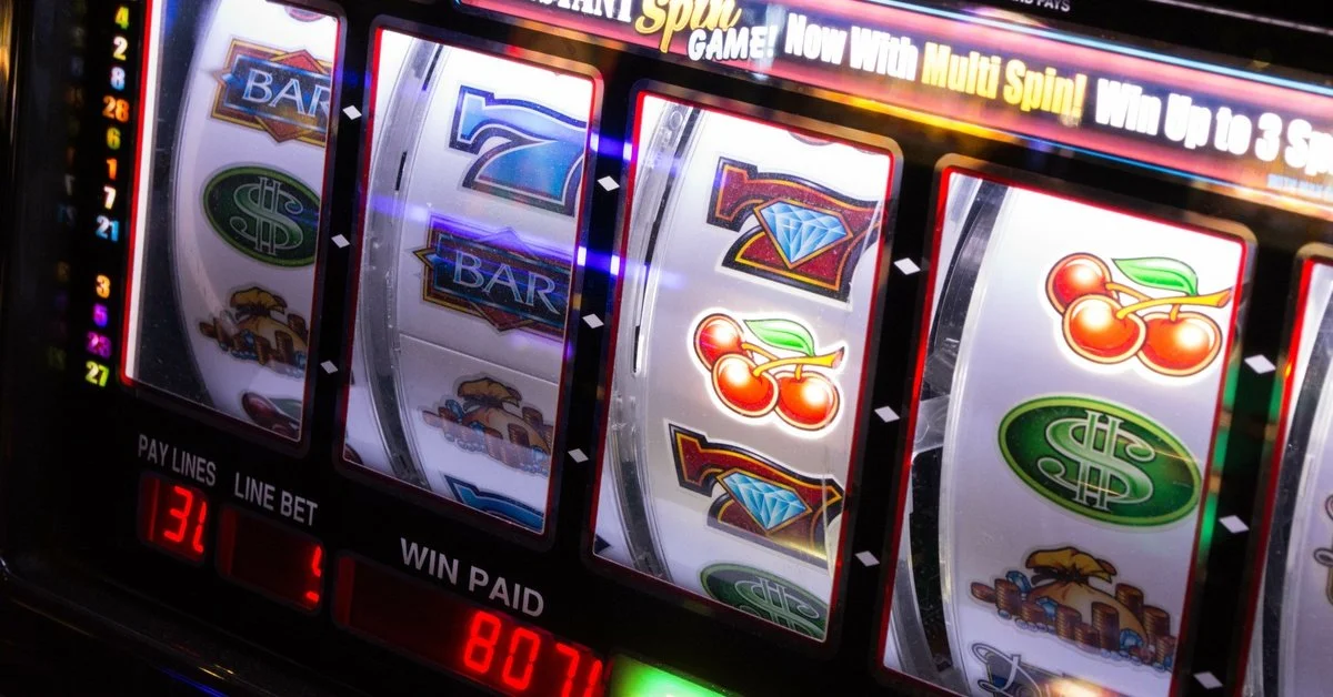 A close-up of a slot machine with four spinning reels, showing paylines, line bets, and win paid at the bottom.