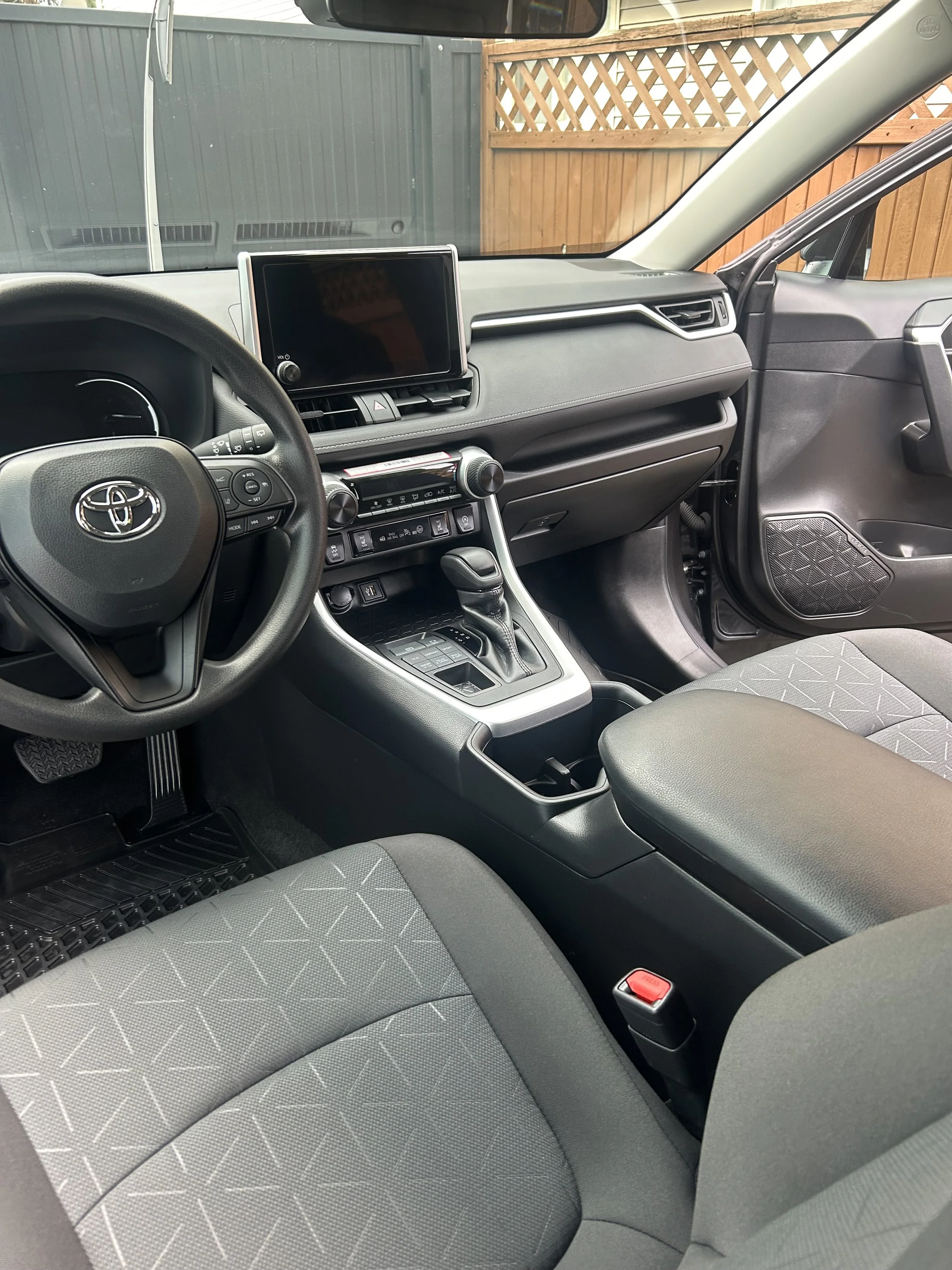 Interior of a car showing dashboard, steering wheel, and front seats.