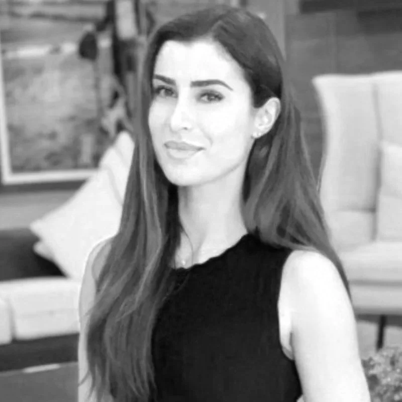 Woman in strapless dress holding hand mixer, black and white