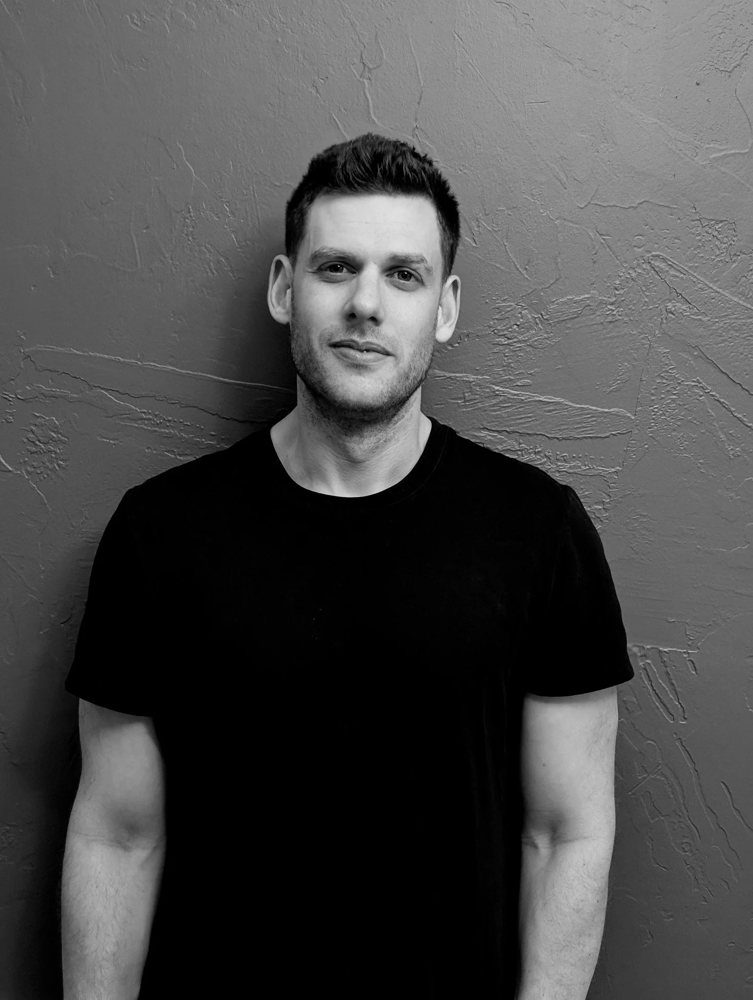 Zach Greenberg portrait in front of textured wall