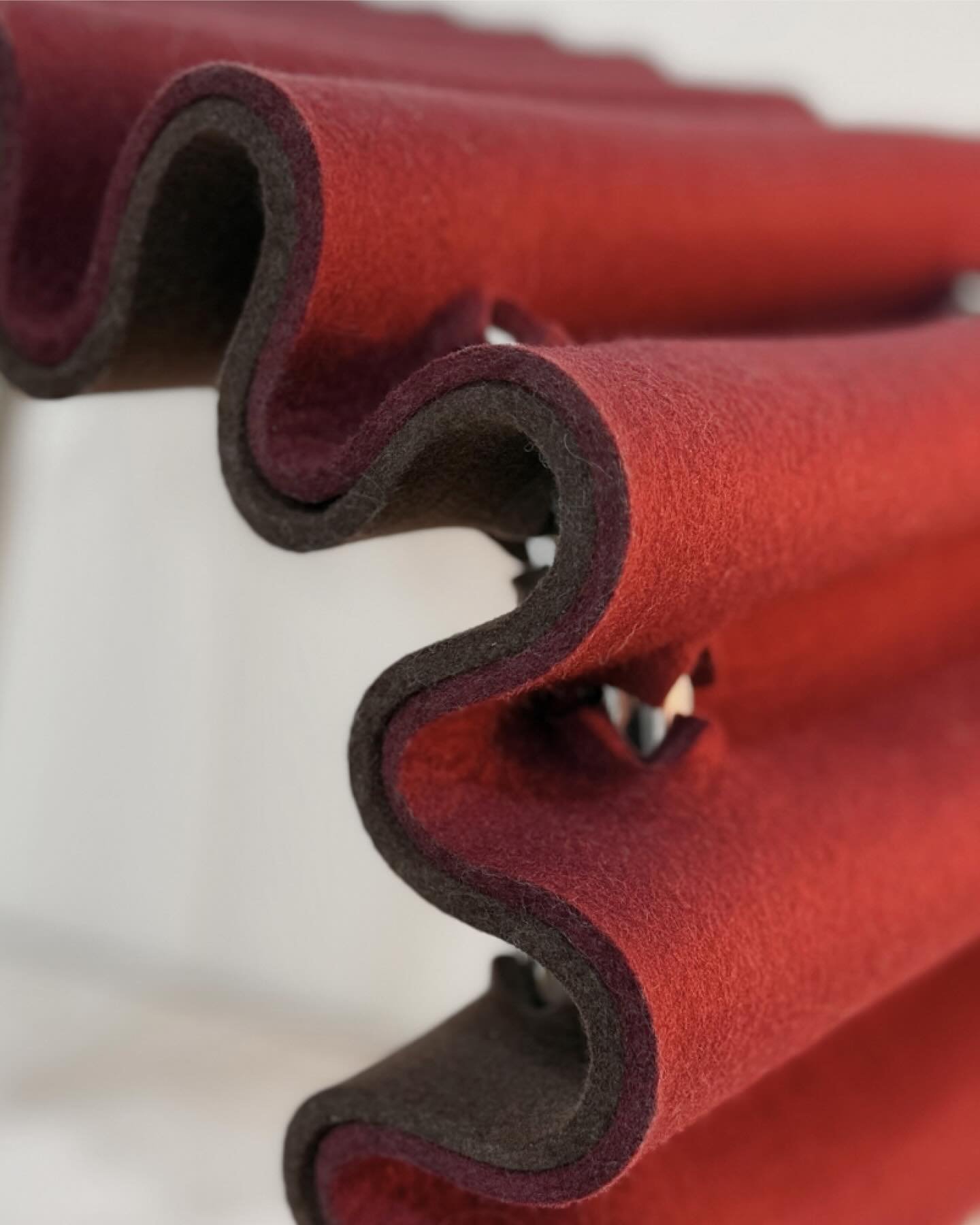 The Linea Collection&rsquo;s Slide Seat rethinks upholstery with an innovative interlocking cut in two layers of felt, seamlessly threaded through the tubular steel frame. This creates both cushioning and structure, without the labor-intensive method