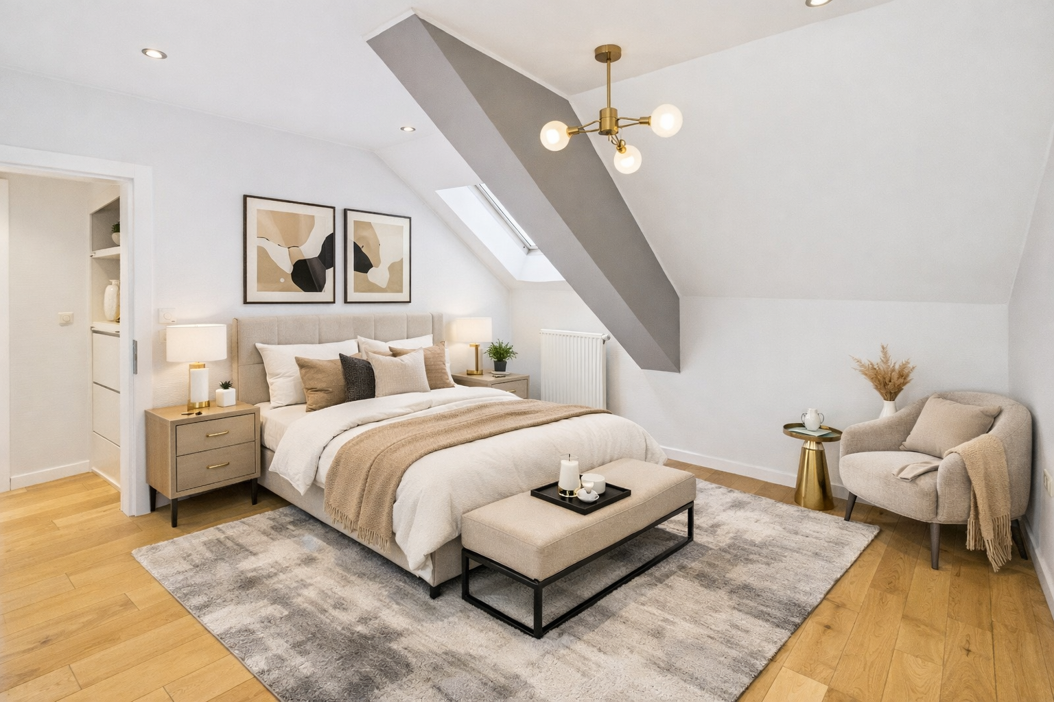 Chambre à coucher moderne avec lit double, coussins beige et blanc, tapis gris sur parquet en bois, lampes de chevet, décoration abstraite, fauteuil beige avec coussin, petite table avec vase de fleurs séchées, décoration neutre et élégante.