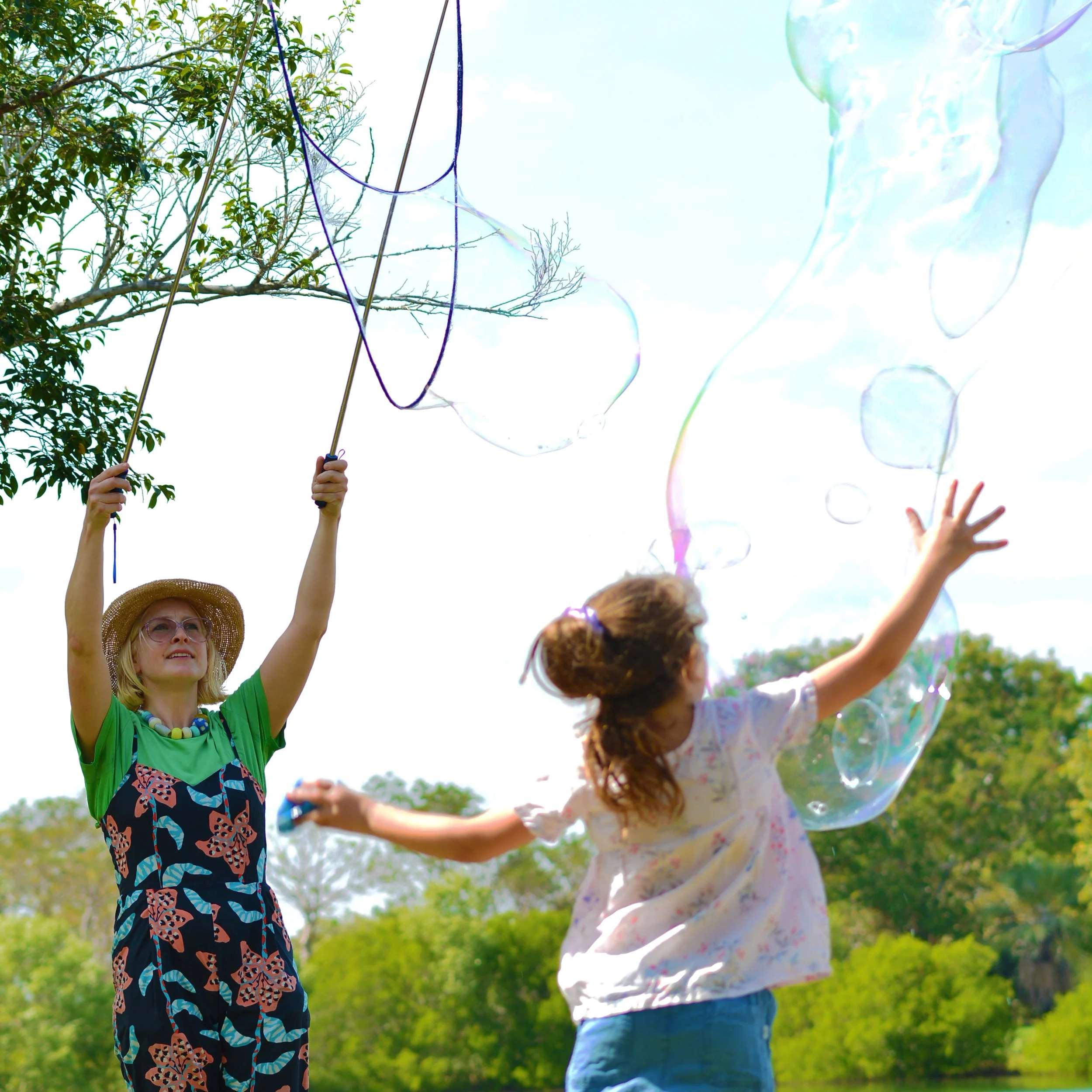 Child jumping for bubbles - Bubble Birthday Party at Lake Alexander 2024
