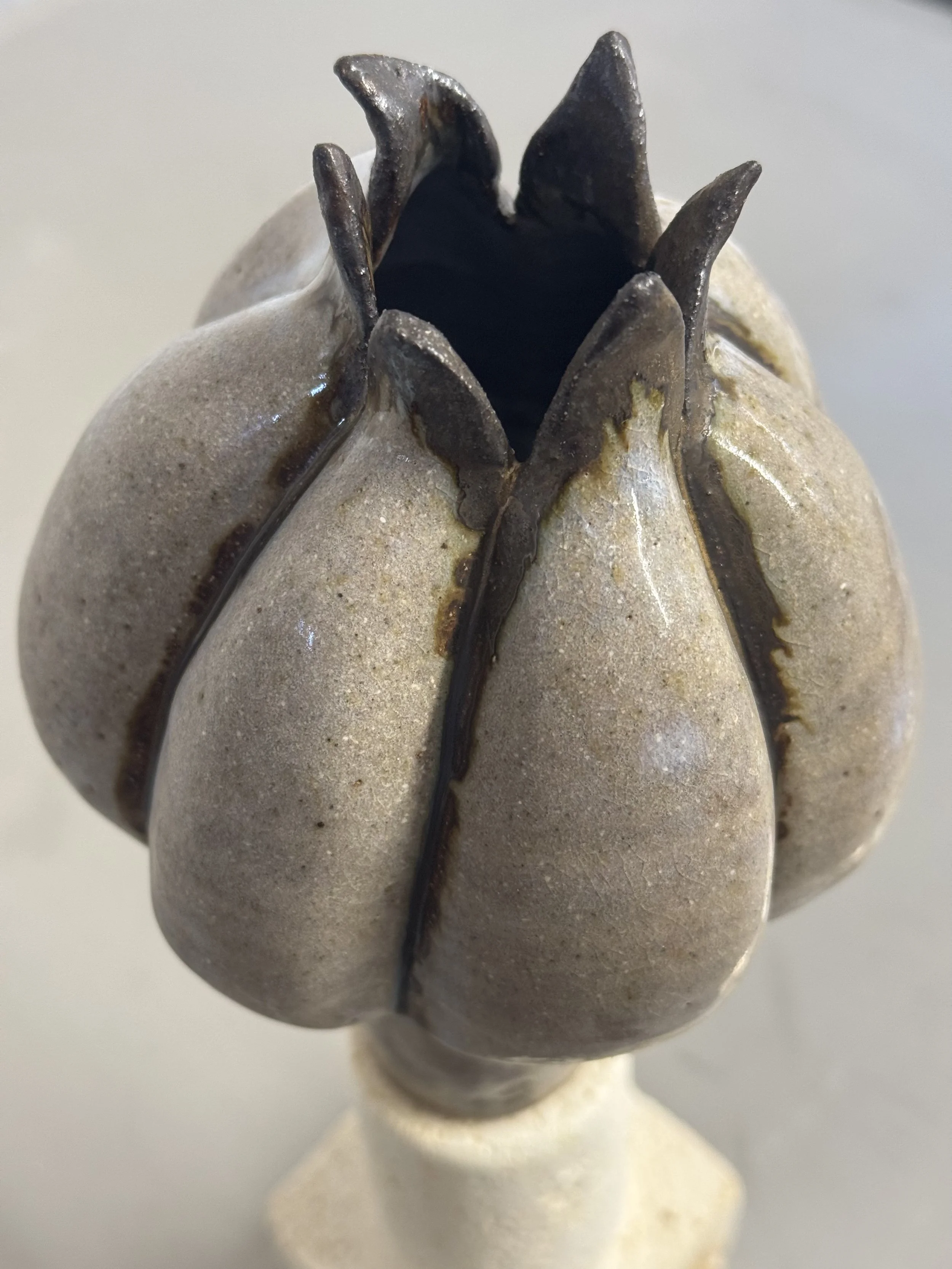 Wheel thrown stoneware form manipulated and stalk stand added
