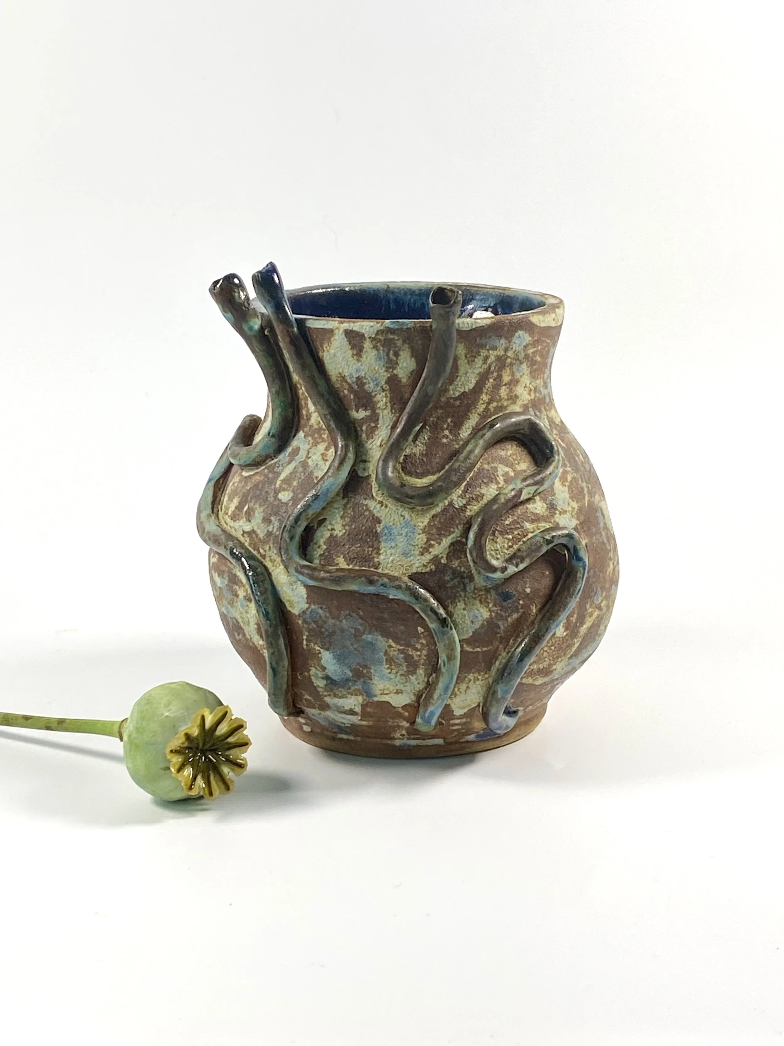 Wheel thrown vessel with surface decoration