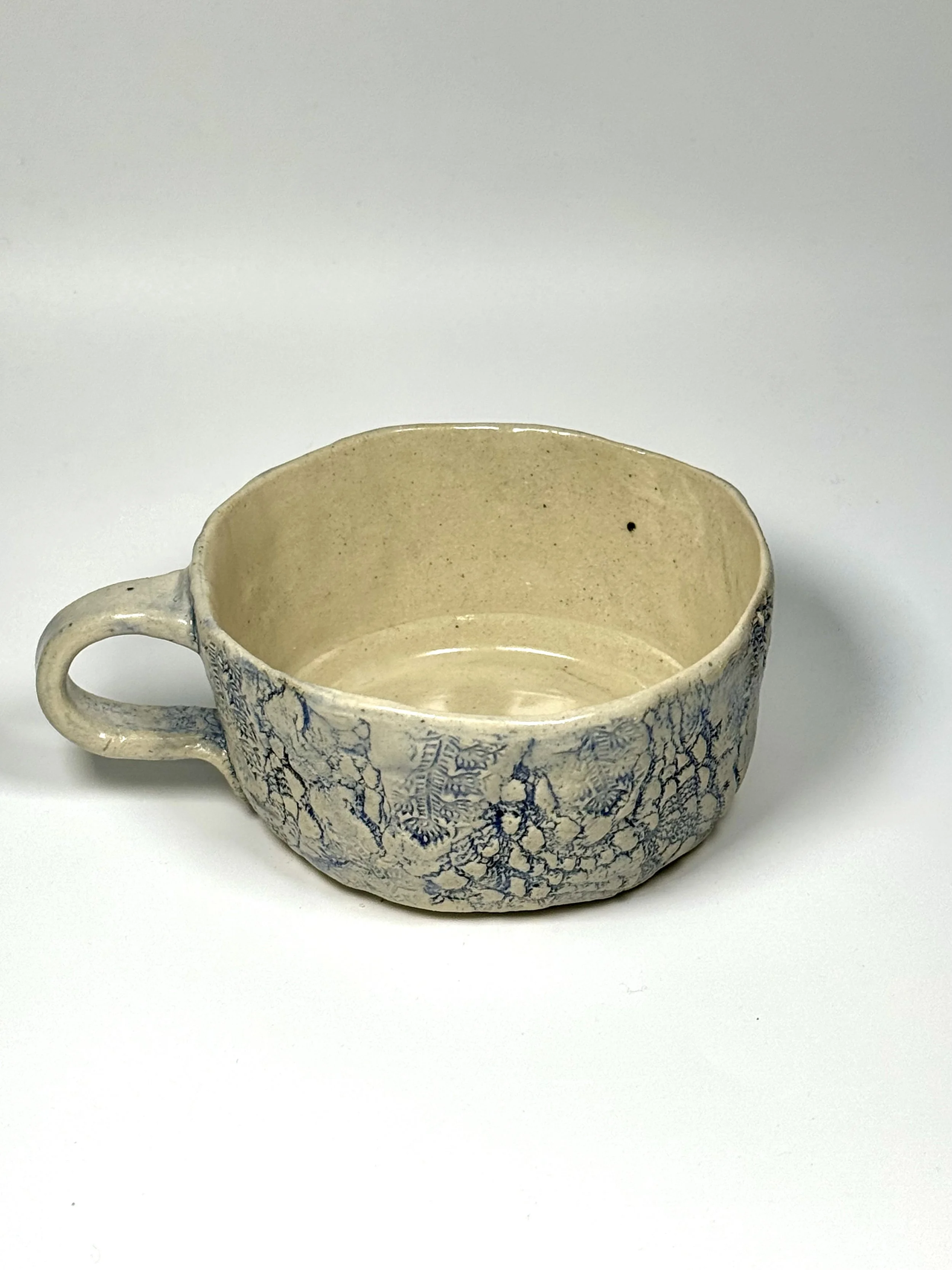 Coffee cup with textured surface