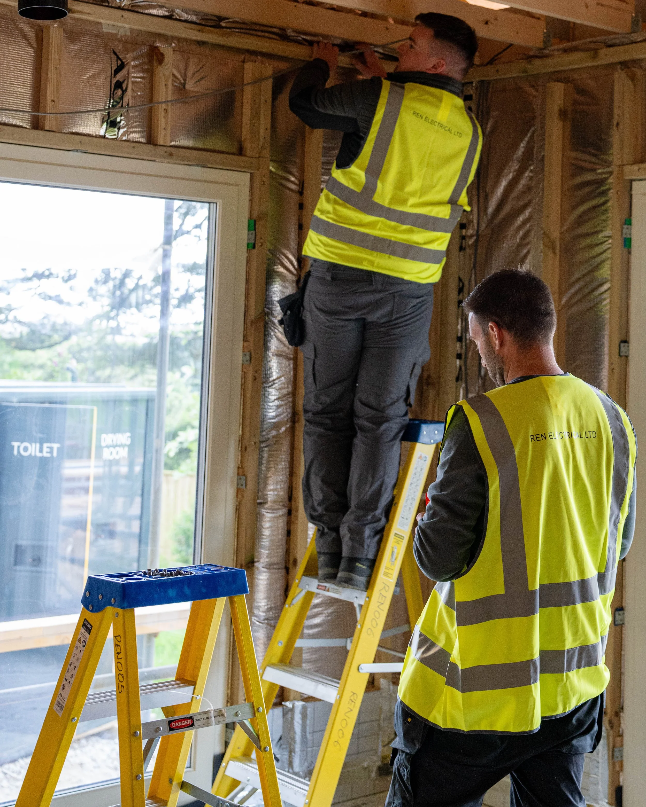 Two members of REN Electrical Working Onsite Together