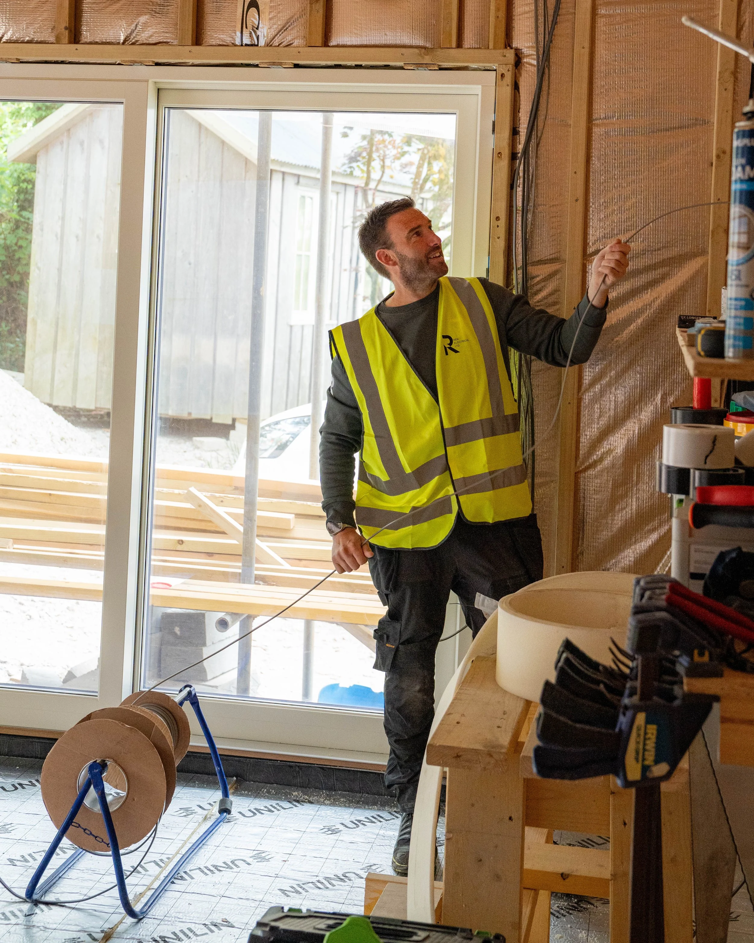 Team member from REN Electrical onsite holding a cable