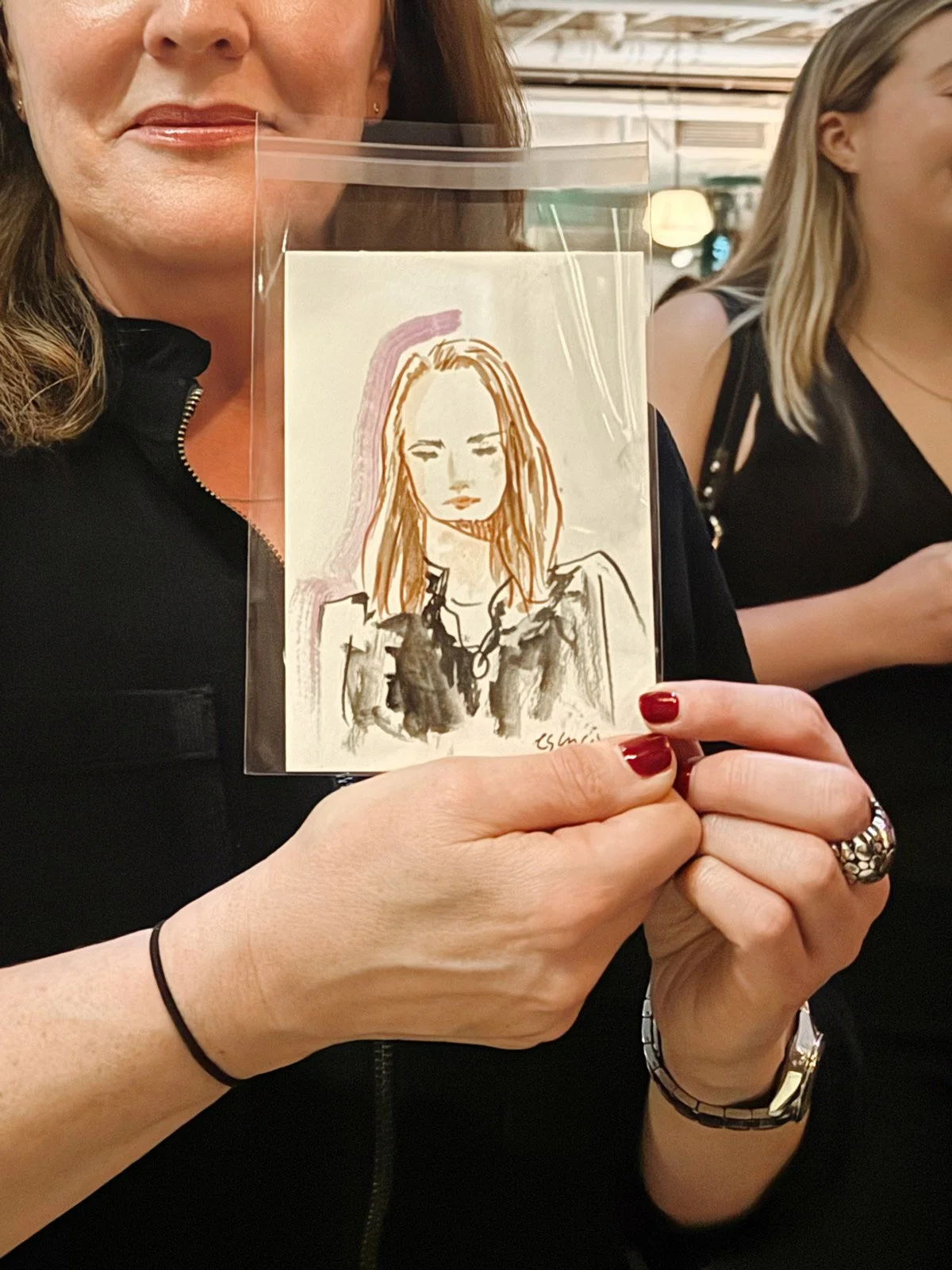 Person holding a sketch of a woman by Eduard Illustrates