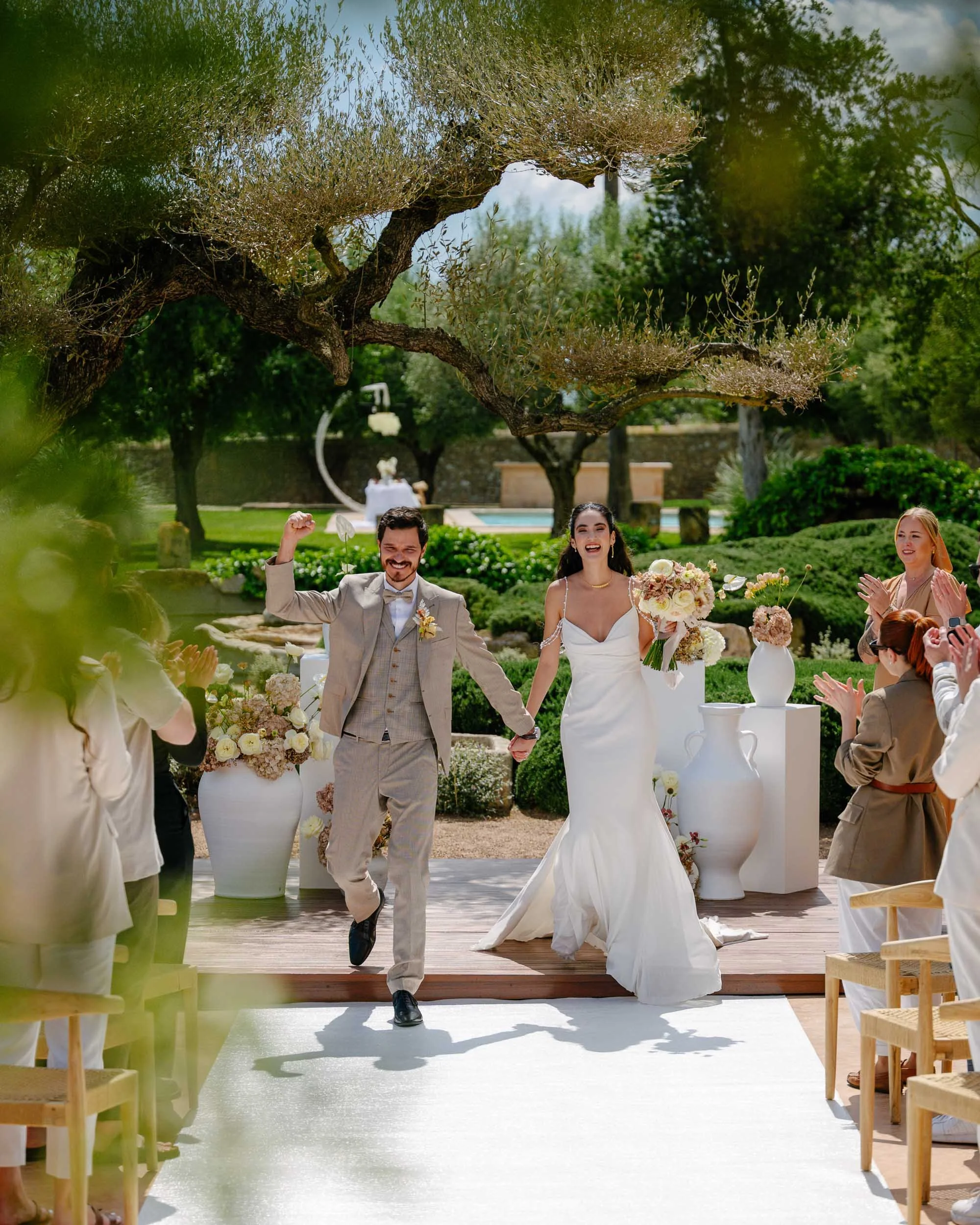 Unposed documentary-style photo of a bride walking the aisle – destination wedding ceremony in Finca Mornetam, Mallorca by Studio Aelina