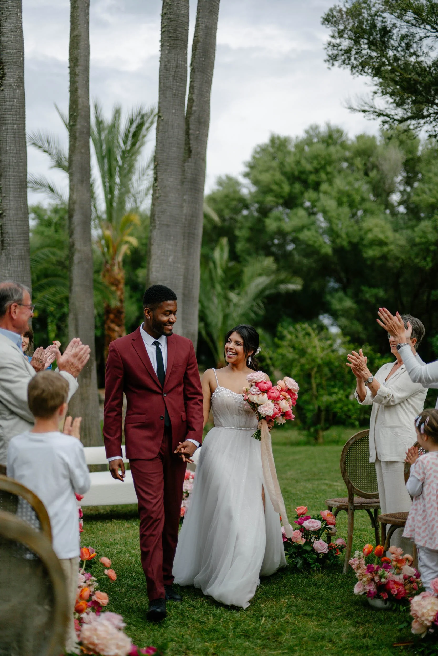 Joyful post-ceremony celebration moment in Mallorca – vibrant, unposed wedding photography by Studio Aelina