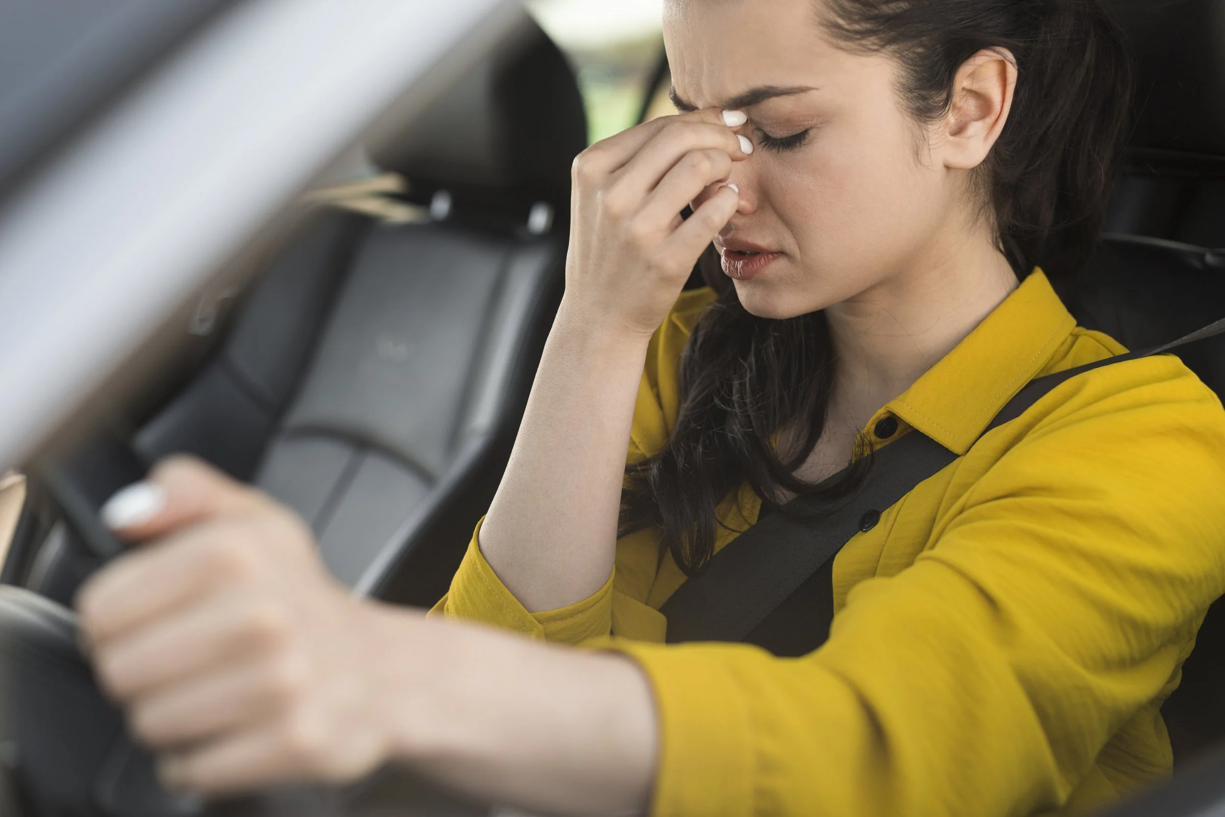 Woman driving with headache