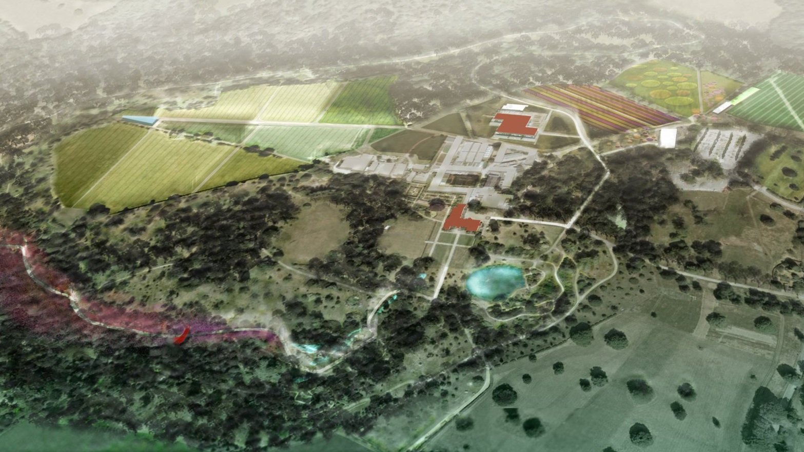 An aerial view of a large, landscaped area with pathways, trees, a pond, and various buildings, including gardens and agricultural fields.