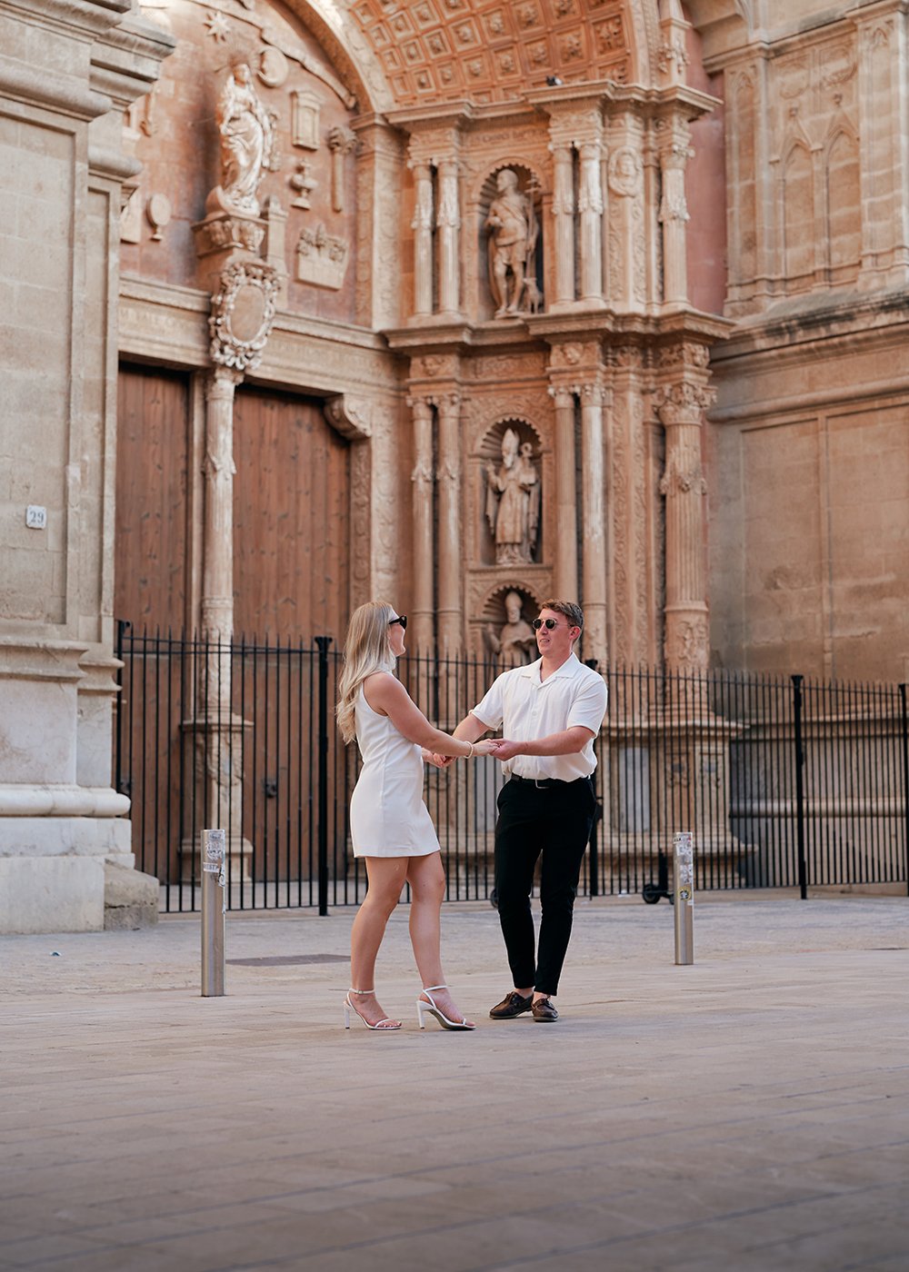 A couple dancing in front of Cathedral of Palma de Mallorca
