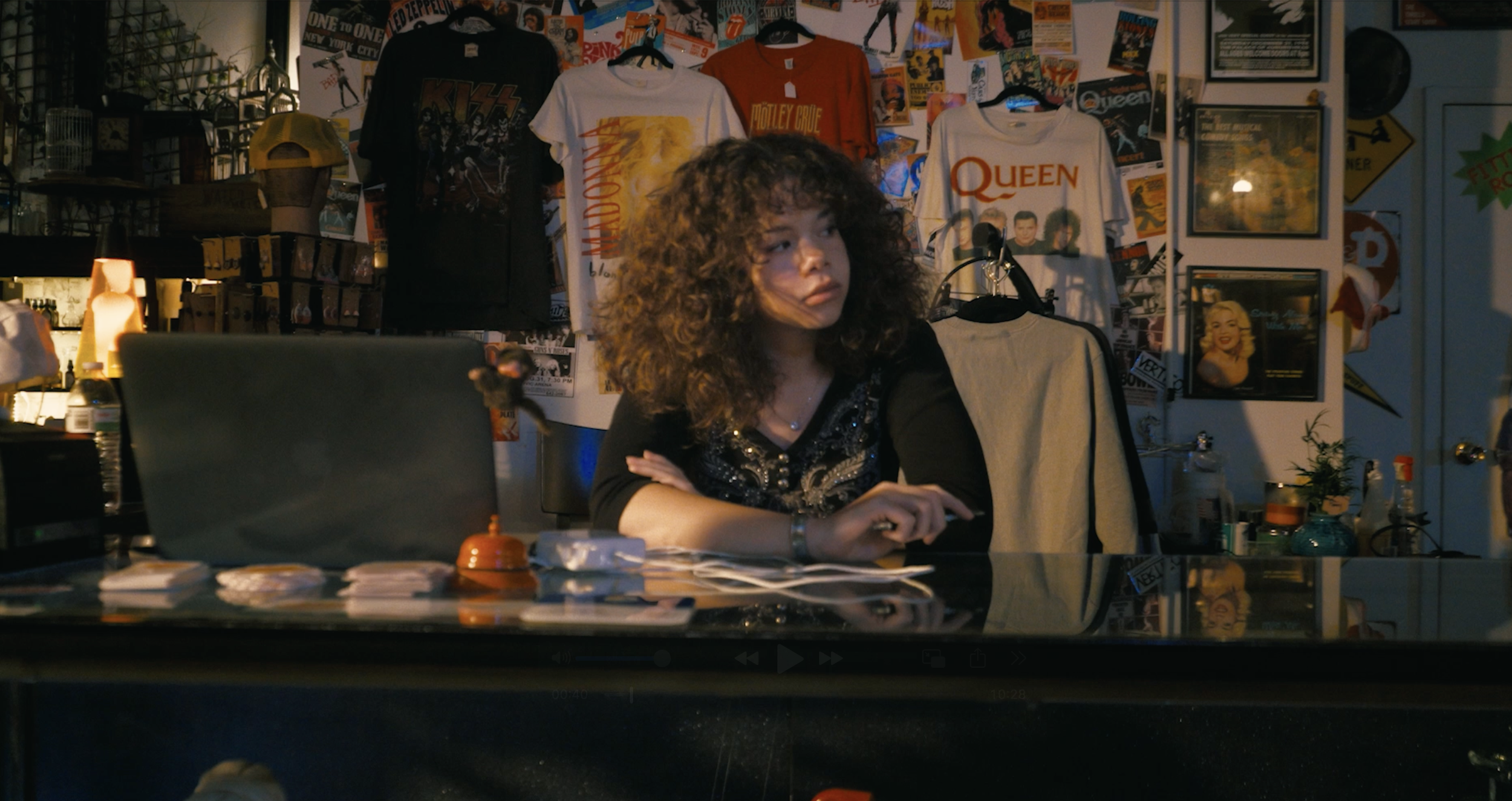 From 'Shadow.' Jade sitting at store counter.