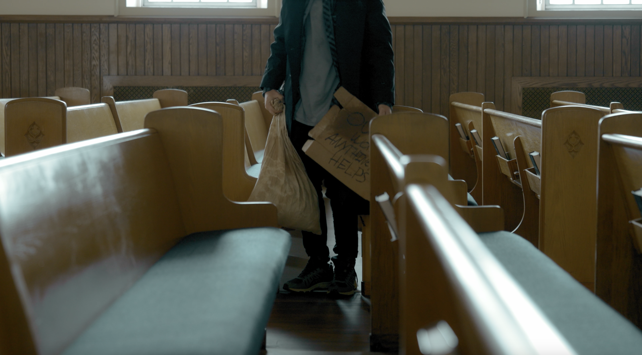 From 'Counseling.' Man gathering things from pews.