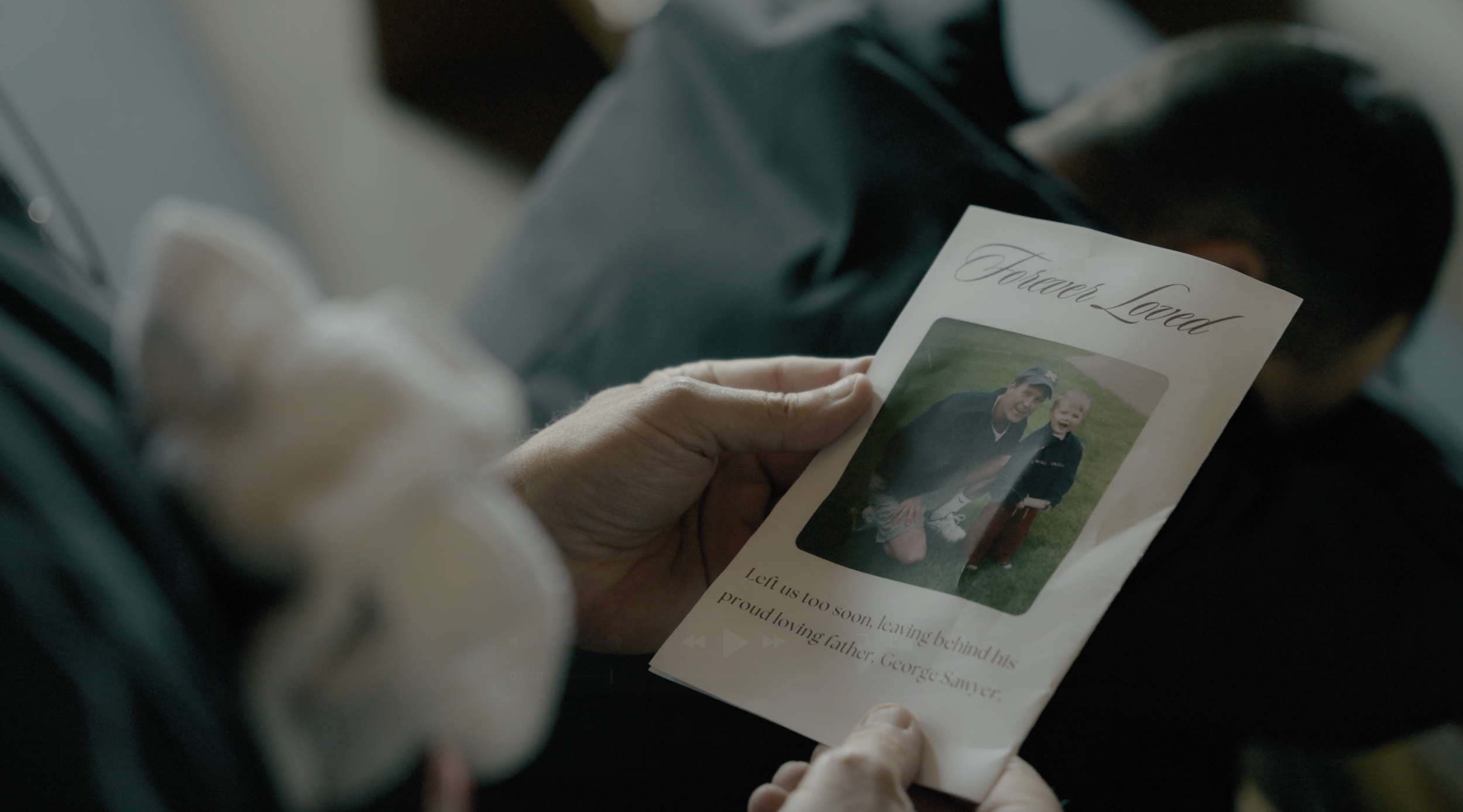 From 'Counseling.' Man holding funeral pamphlet. 